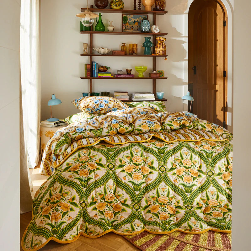 bed with the Margaret Scalloped Coverlet by Sage & Clare - with floral pattern in green and yellow