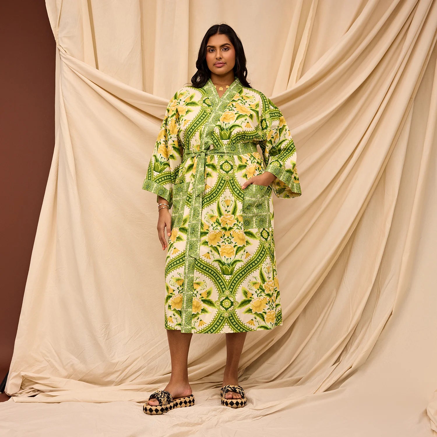 lady wearing the green and yellow floral organic cotton robe by Sage & Clare
