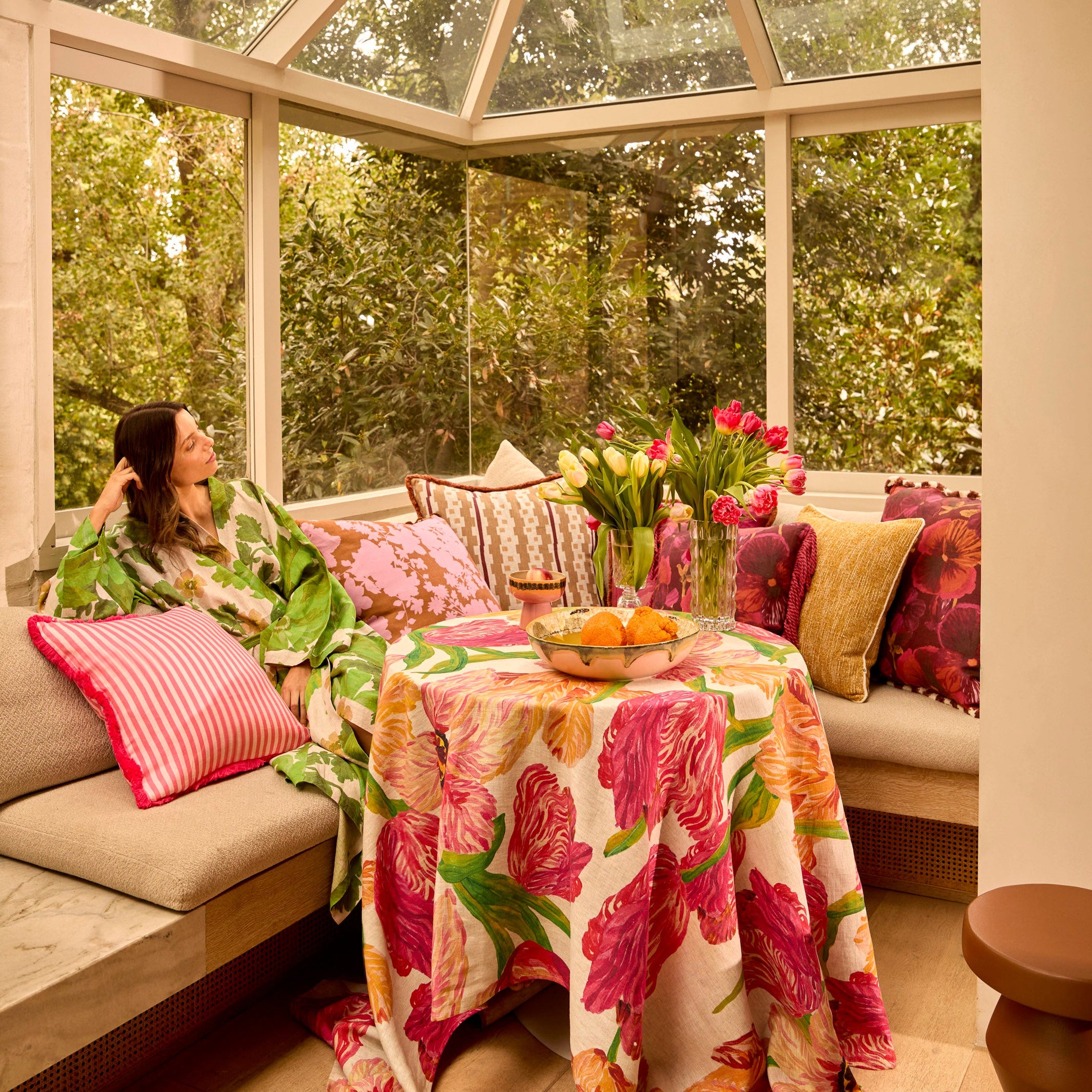 Model wearing Marigold Leaf Linen Robe in sunroom showing full length and tropical leaf pattern