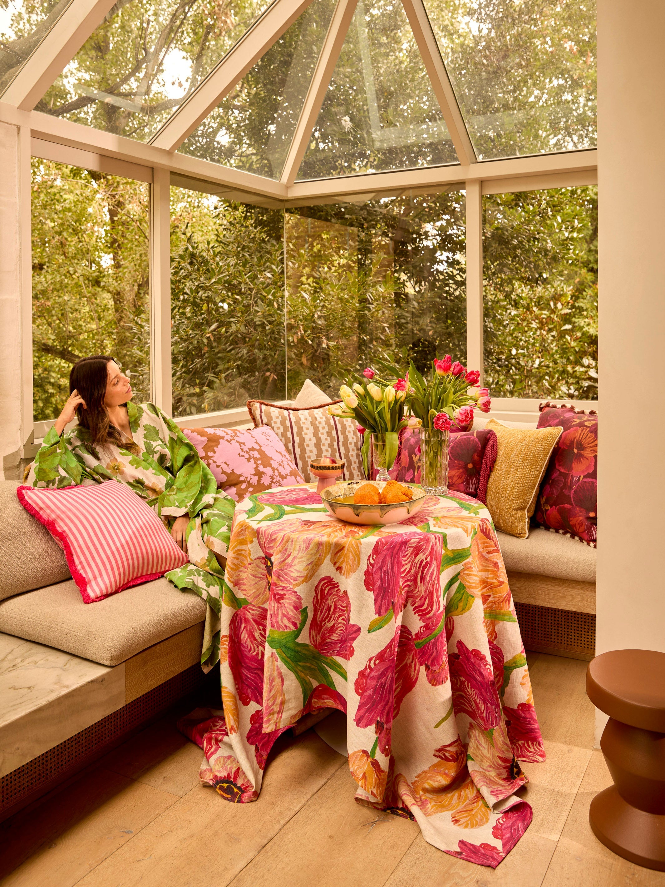 Model wearing Marigold Leaf Linen Robe in sunroom showing full length and tropical leaf pattern