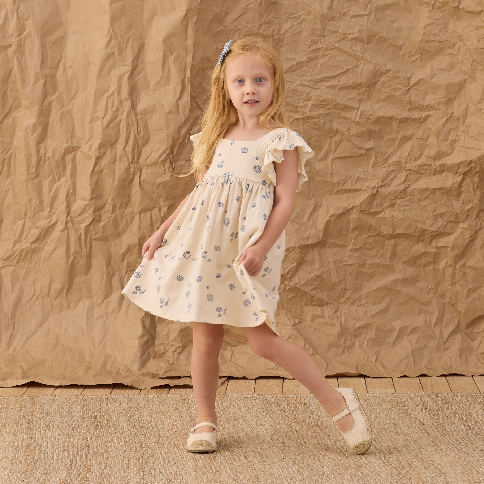 Young girl in the Mariposa Seashell Dress | Rylee + Cru