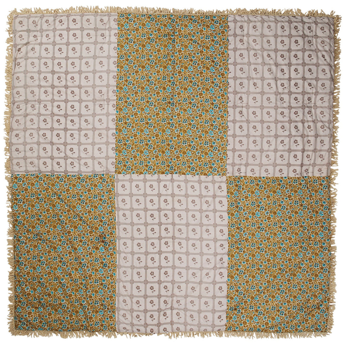Reverse side of velvet bedcover laid flat, showing patchwork panels of cream grid floral and teal gold ditsy floral print with fringe trim