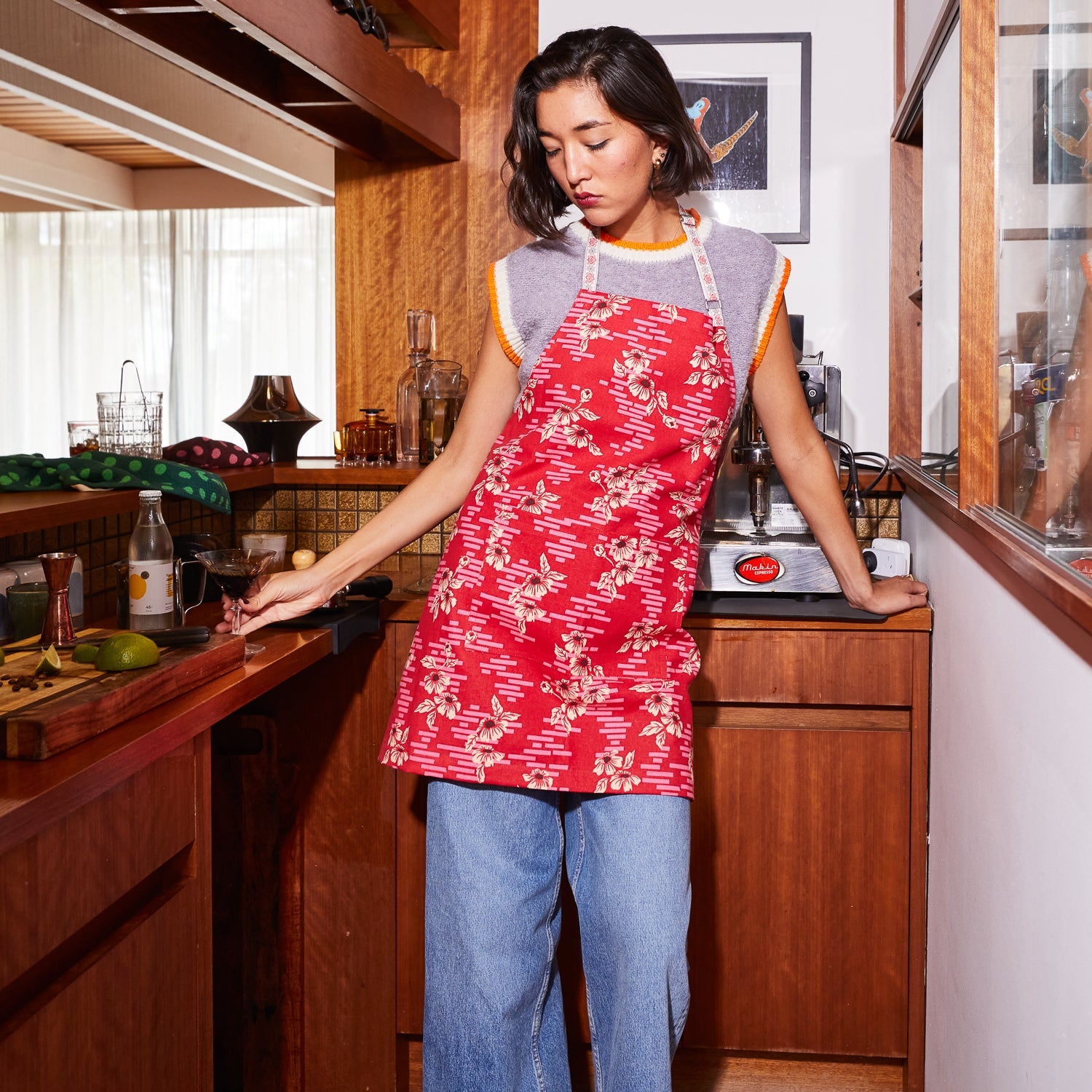 Marta Cotton Apron by Sage Clare with red floral pattern and adjustable straps for kitchen cooking