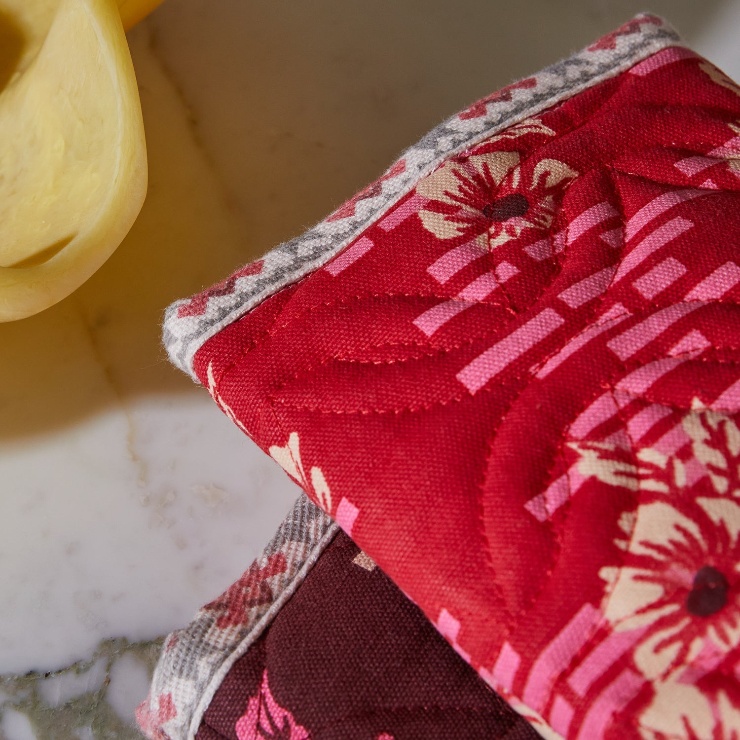 Close-up detail of Marta Oven Mitt showing complementary trim binding and polyester filling construction