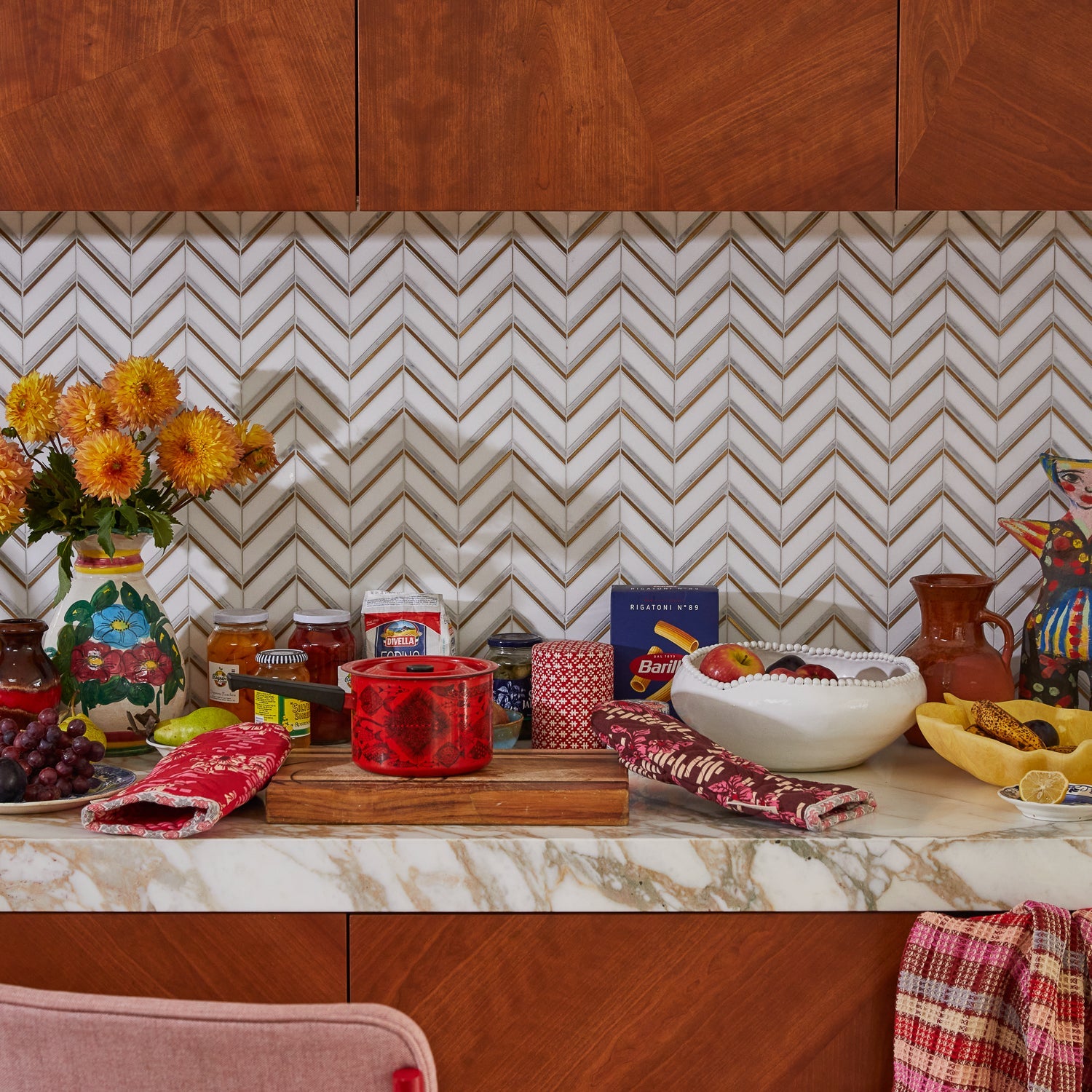 Modern kitchen counter display featuring Marta Oven Mitt Set with chevron tile backsplash and cooking essentials