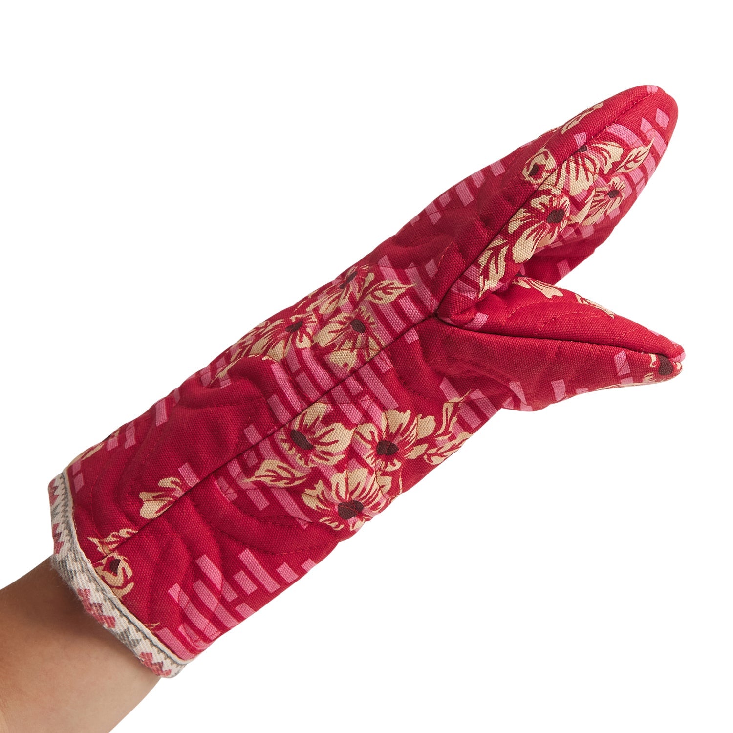 Hand wearing red Marta Oven Mitt demonstrating fit and floral pattern with heat protection features