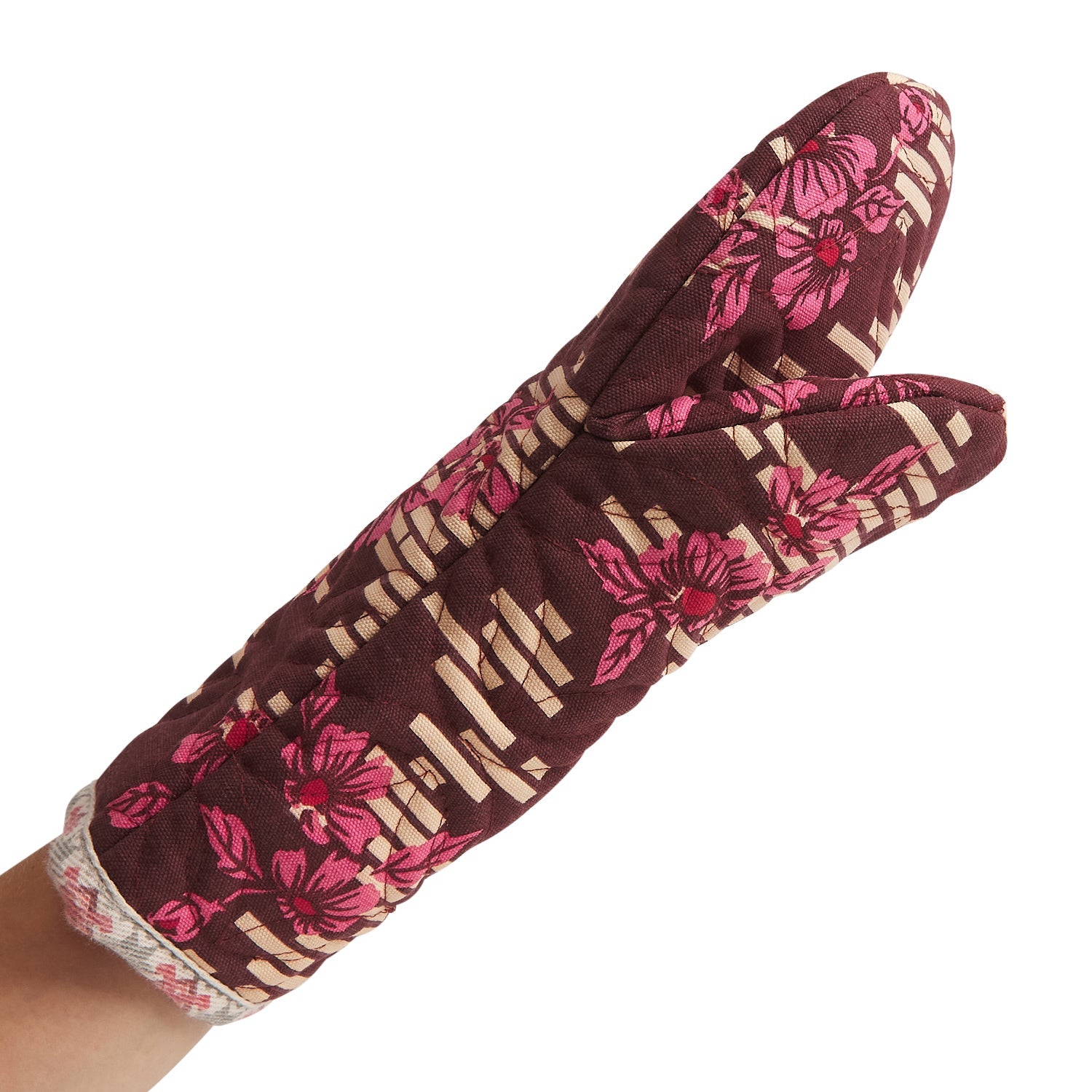 Hand wearing burgundy Marta Oven Mitt showing floral design and practical kitchen safety functionality