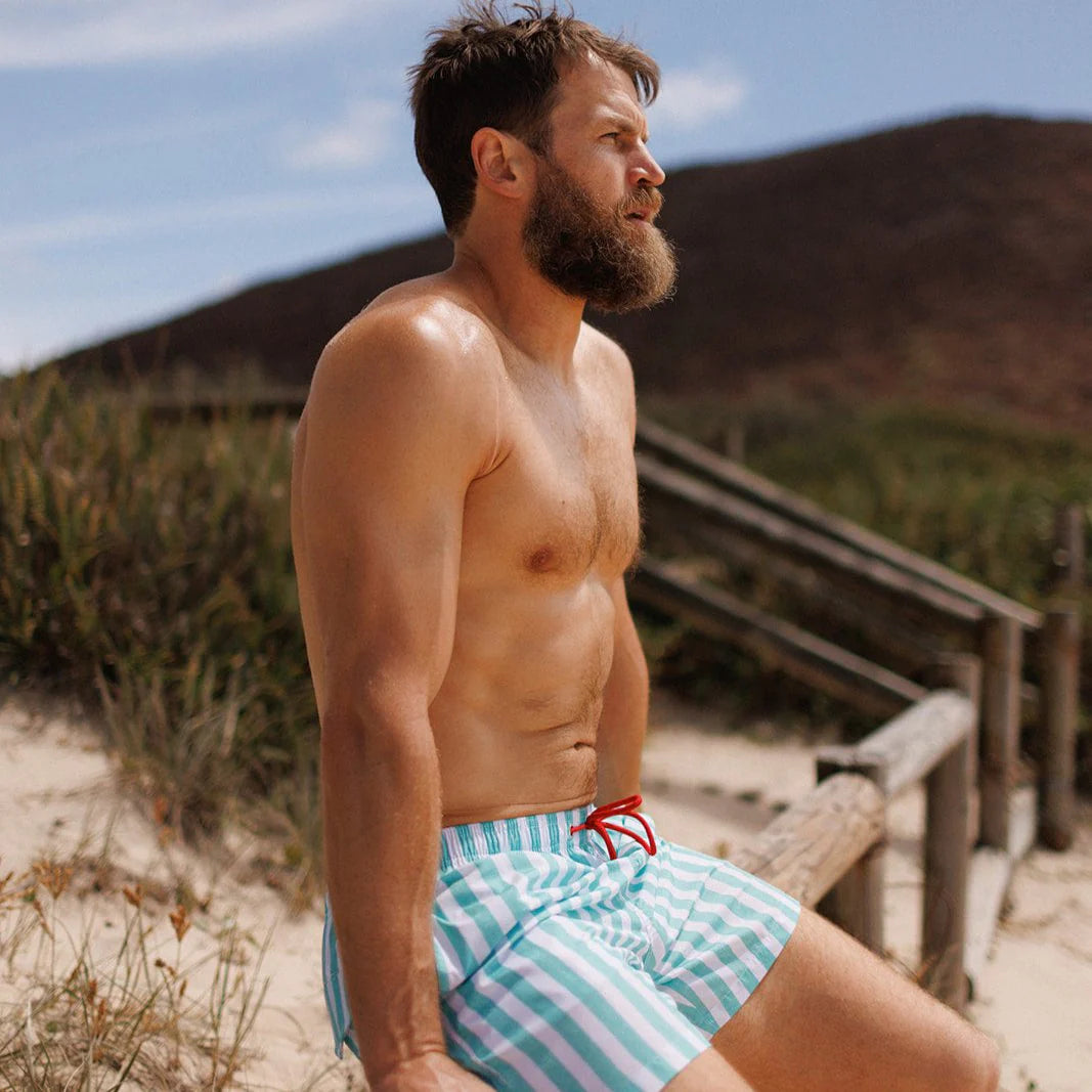 Man wearing the Mint Flare Swim Shorts by Swim Shady