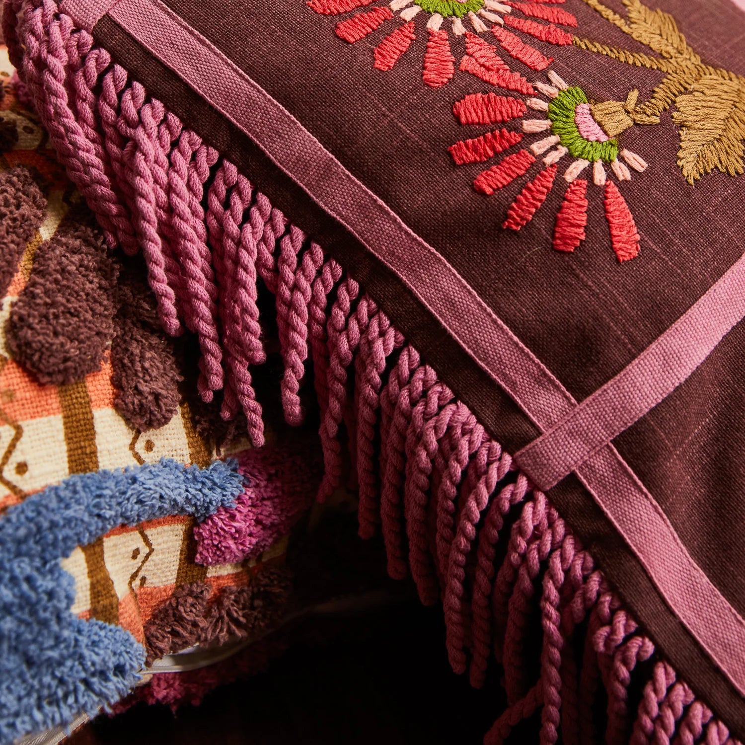 Mira Embroidered Cushion Clove by Sage & Clare close up details of fabric and colours purple and pink and red