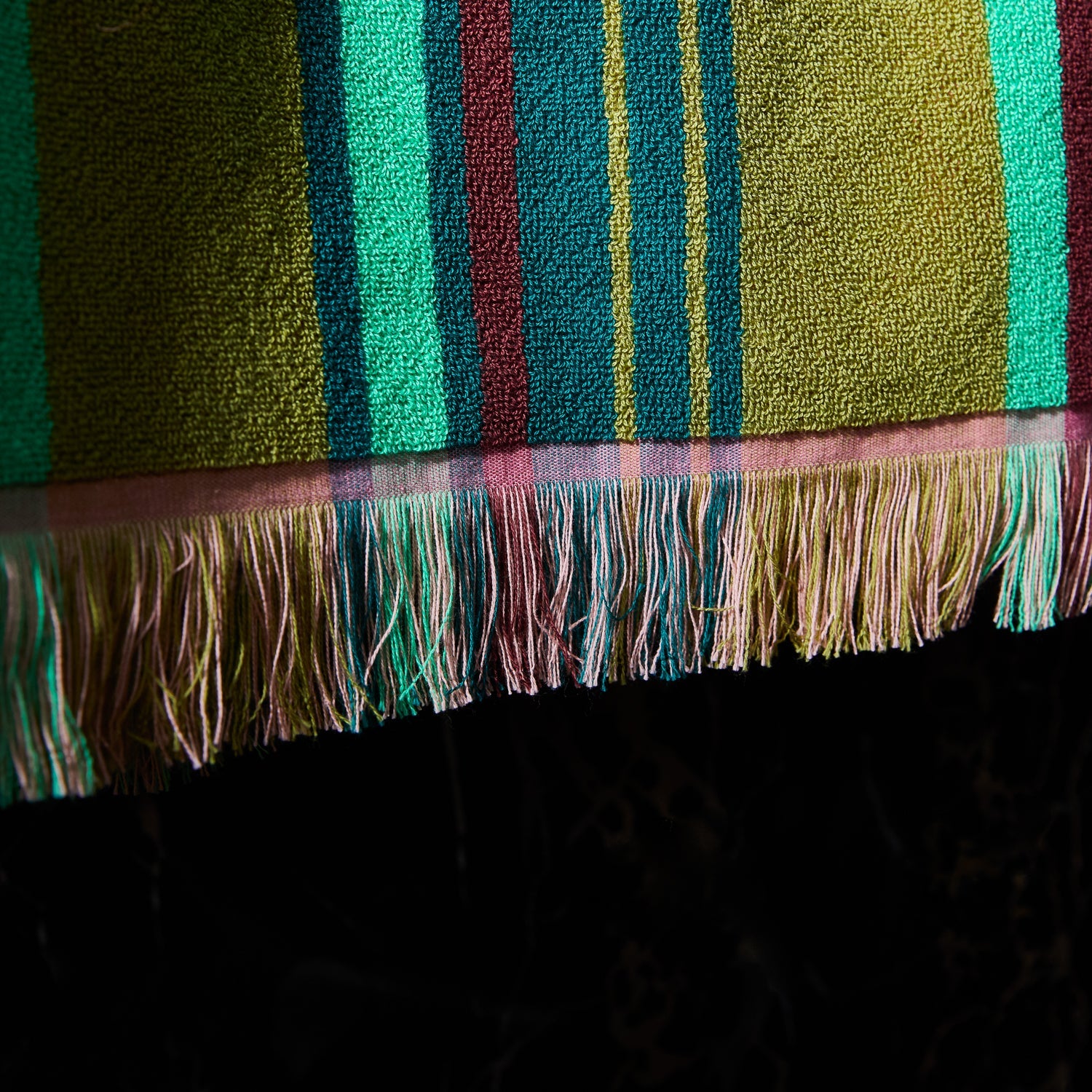 Close-up detail of Nicolette bath sheet fringed border and lightweight terry cotton weave texture