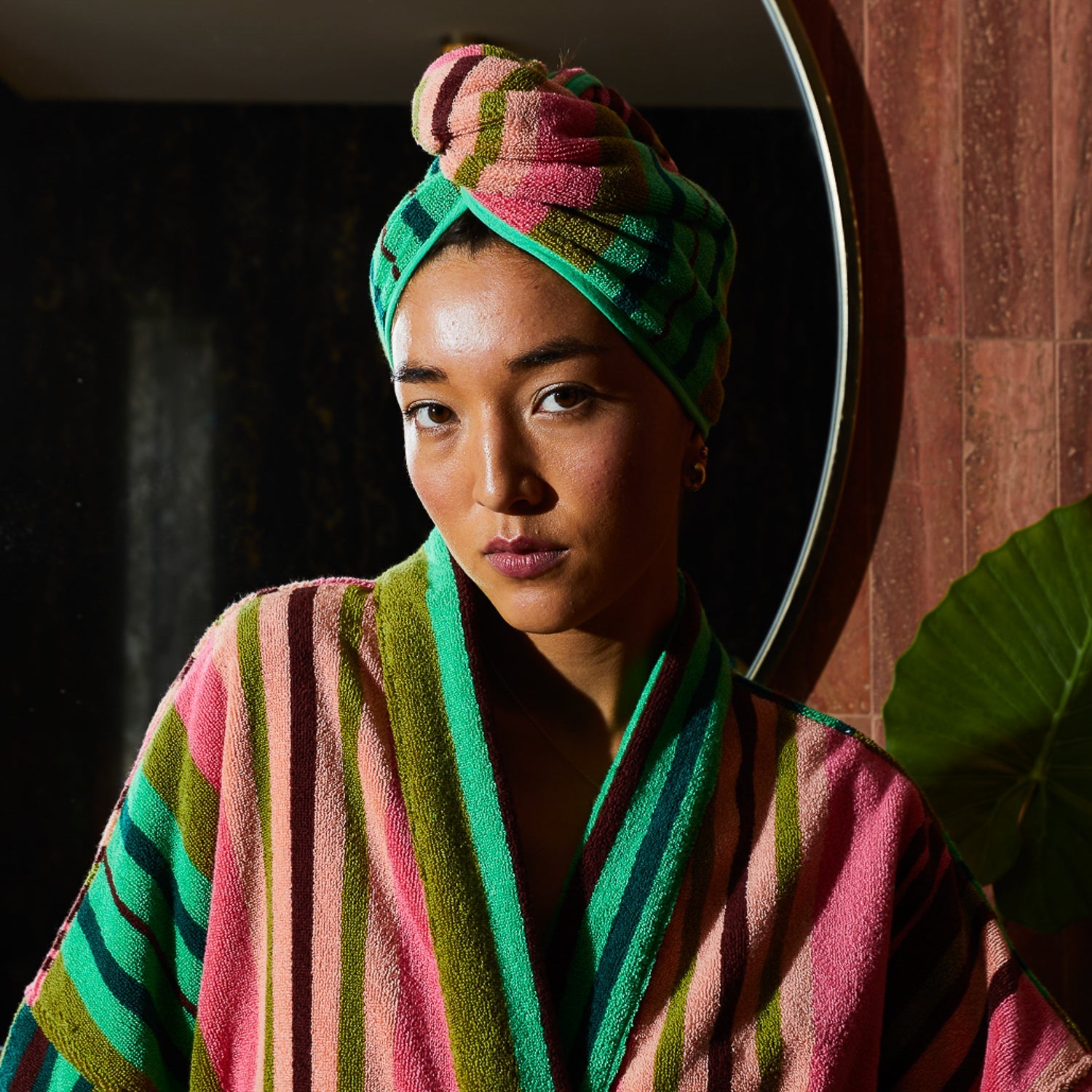 Woman wearing Sage & Clare Nicolette hair wrap in juniper green after shower