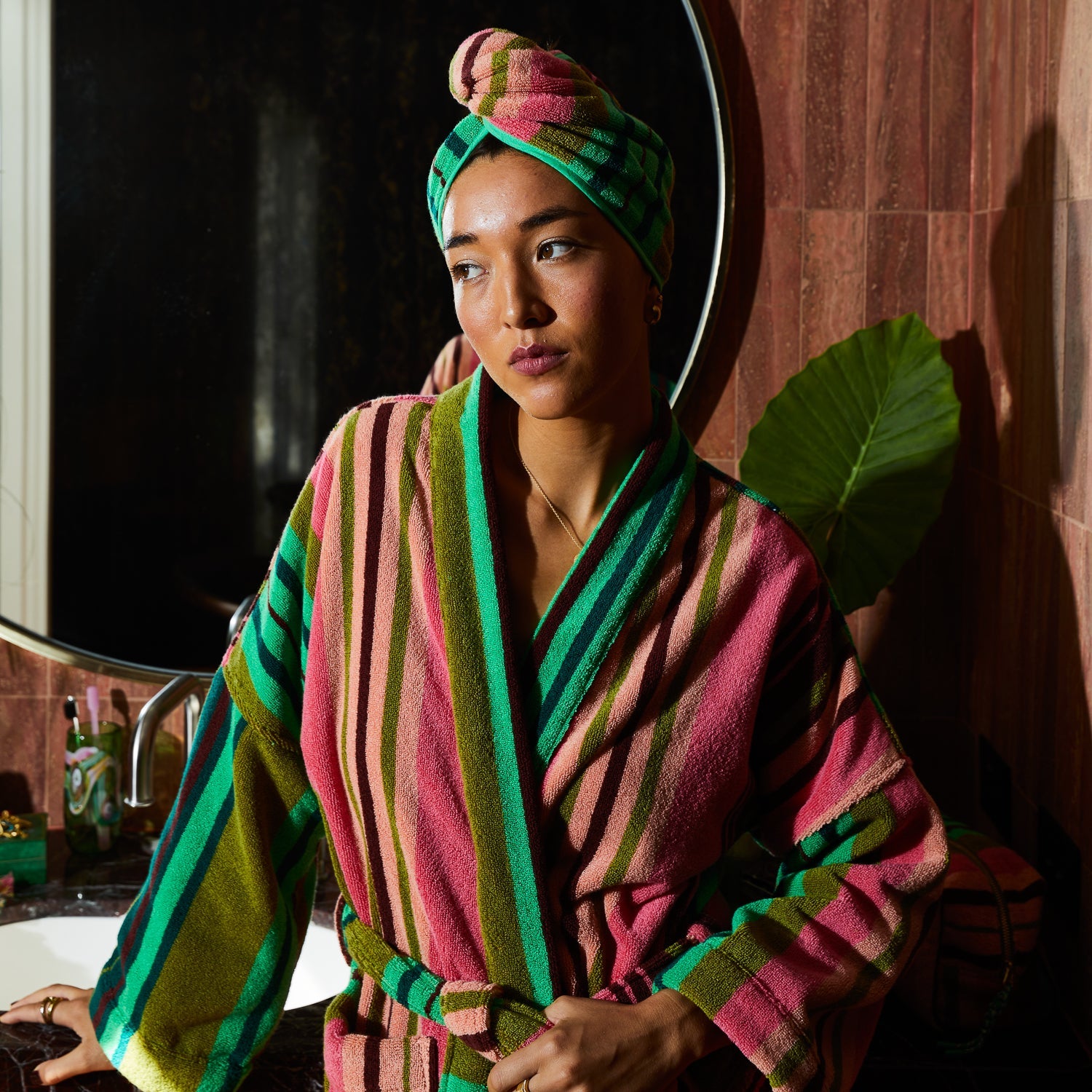 Lifestyle shot of woman using absorbent terry towelling hair wrap post swim