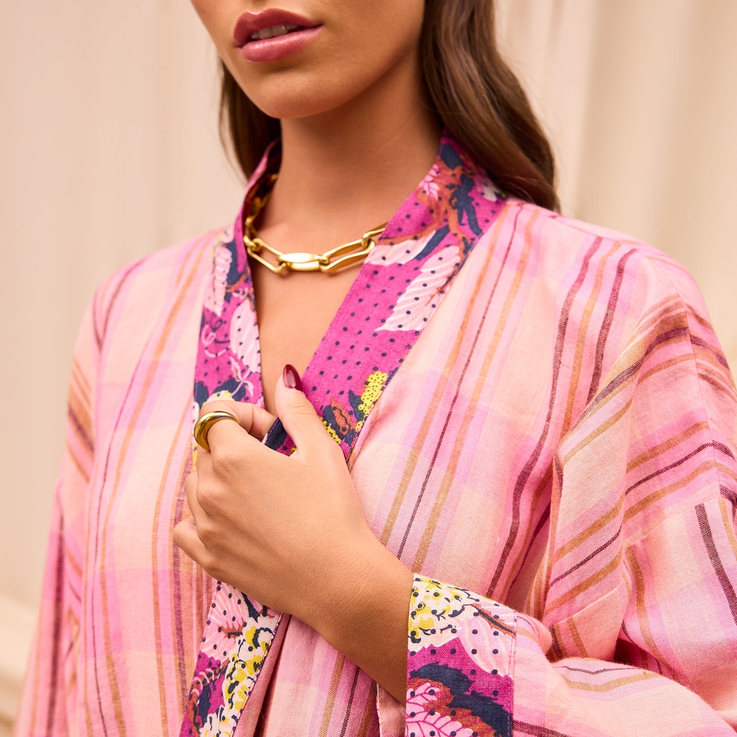 Close-up detail of Nicolette Linen Robe showing pink striped fabric and colorful floral patchwork trim