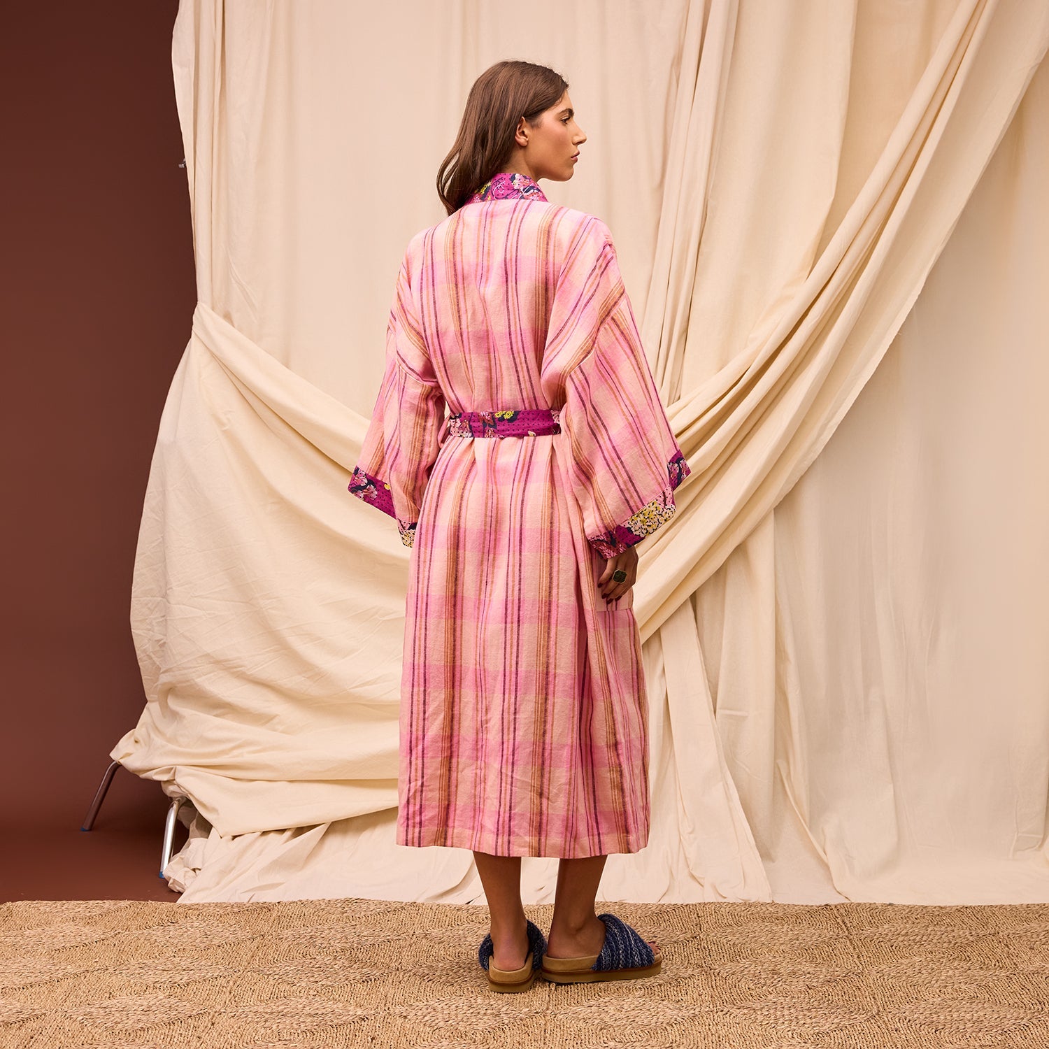 Back view of Nicolette Linen Robe Poudre displaying pink striped pattern and floral contrast details