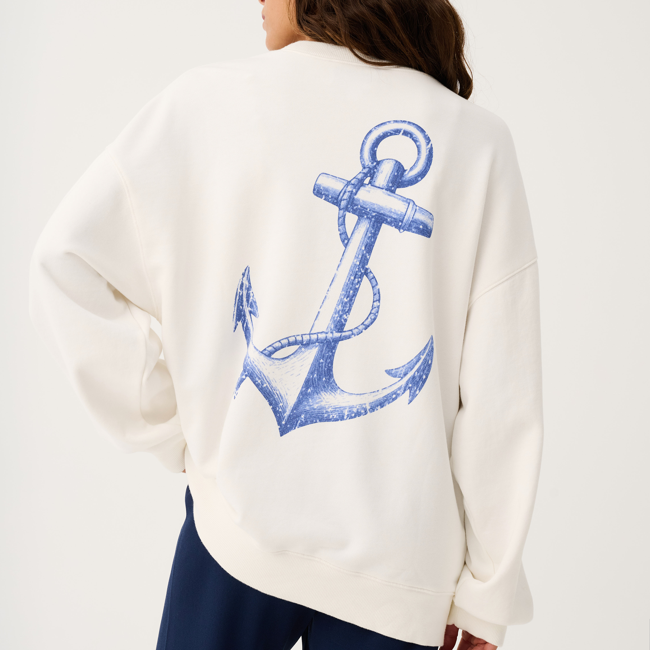 Back view of Nina Sweater in white showing large blue anchor graphic print