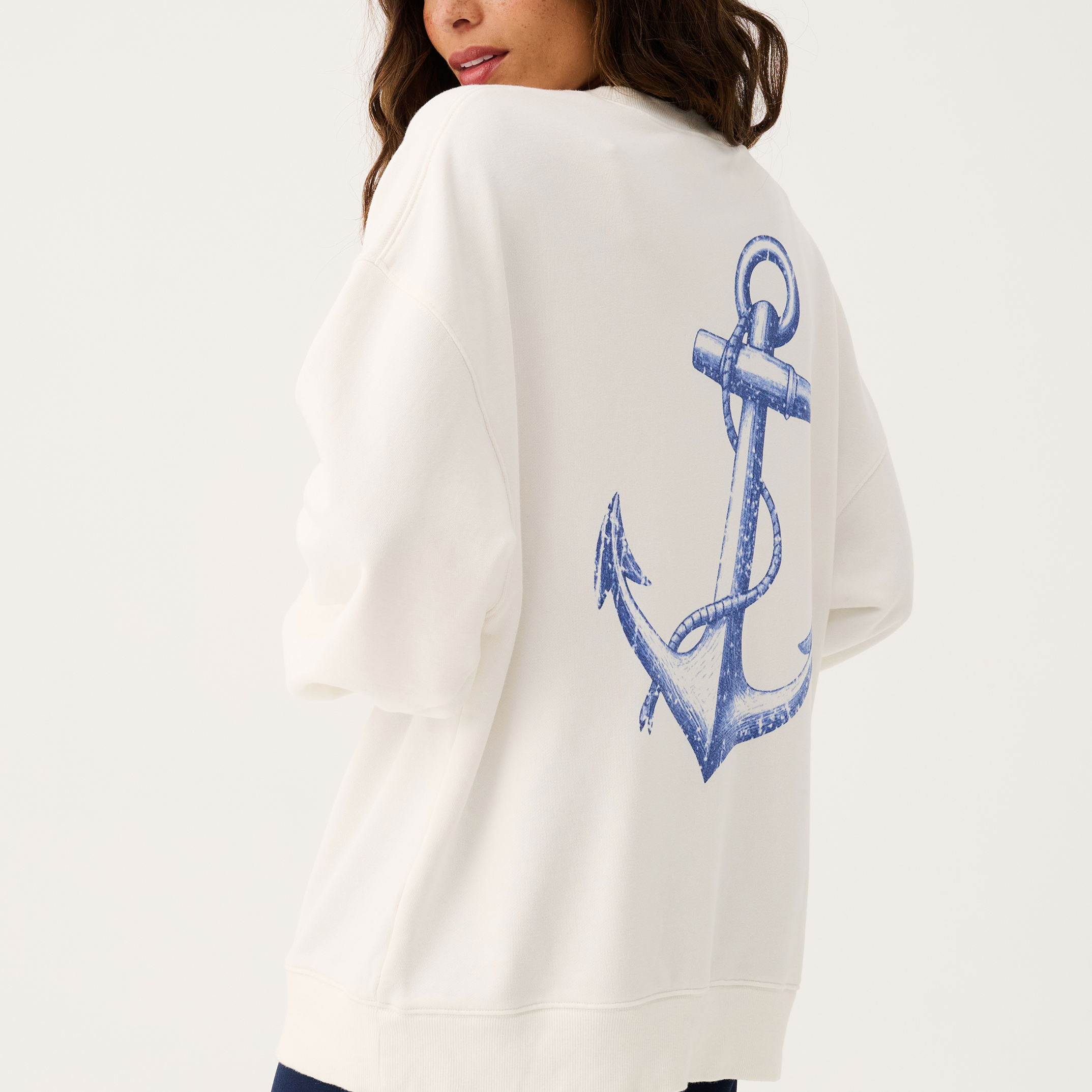 Side angle of Nina Sweater showing blue anchor design on back hem
