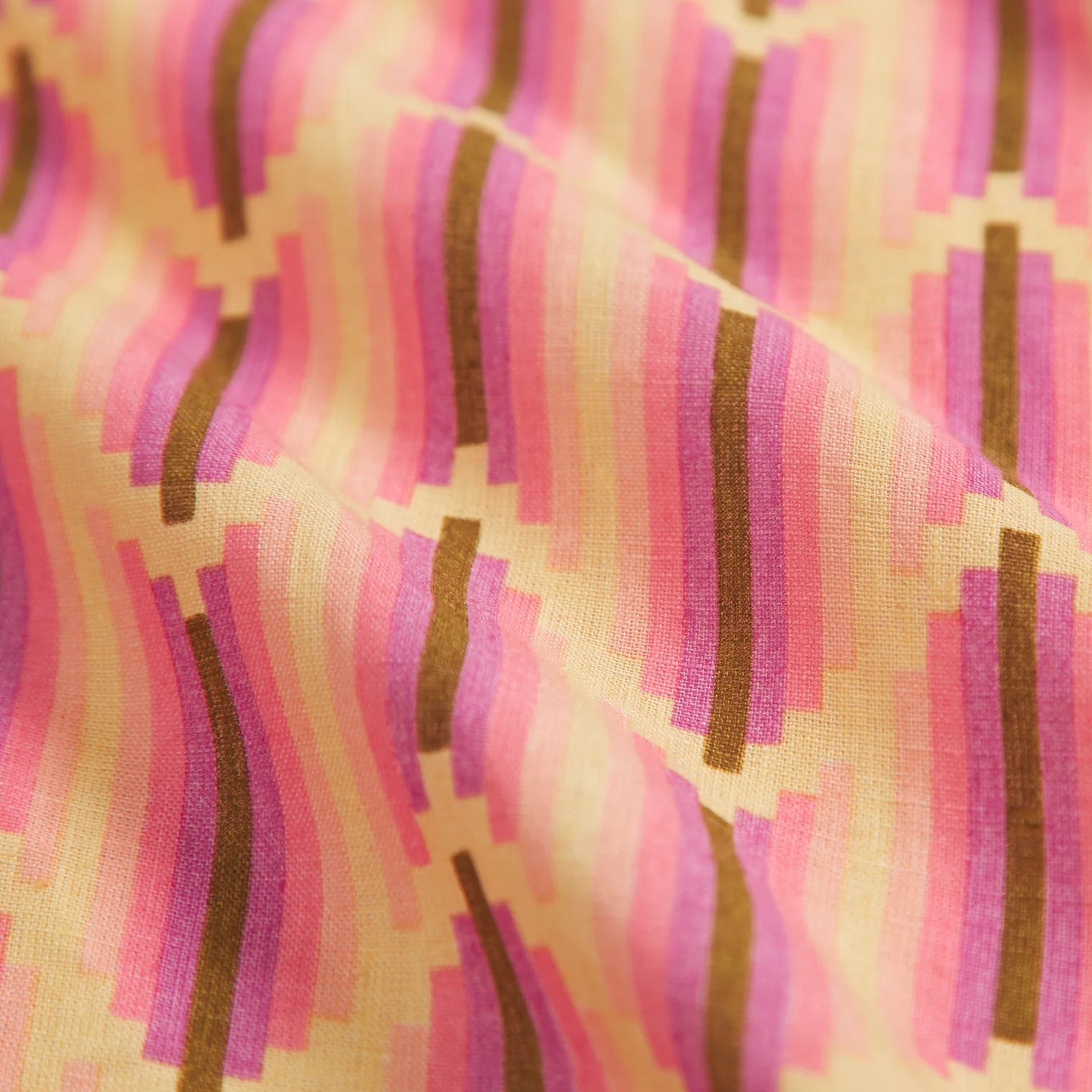 details of the retro Nisha posy tablecloth by Sage & Clare with pink, brown and beige colouring