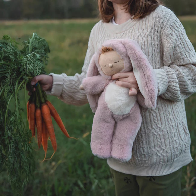 Cozy Dinkum Bunny Flopsy Rose by Olli Ella held by a child who is also holding carrots