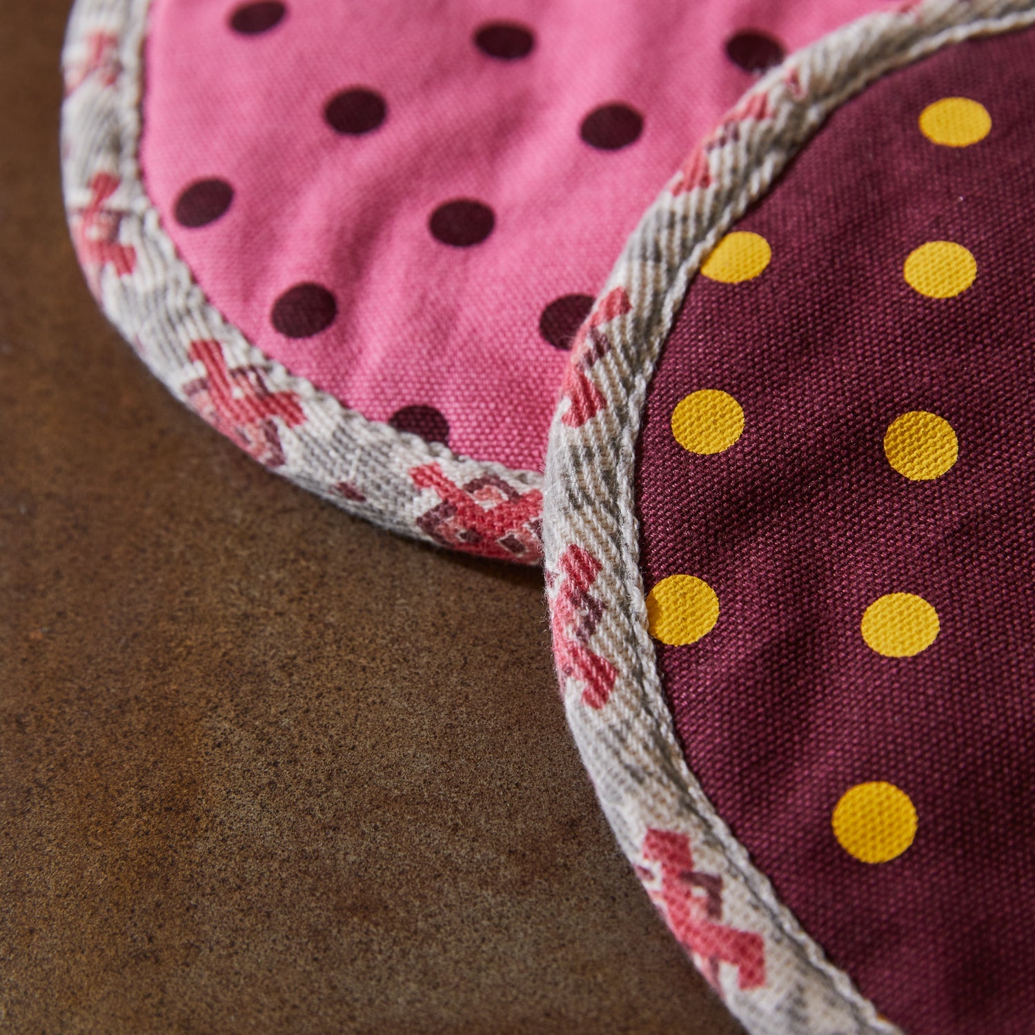 Close-up view of polka dot fabric texture and rope binding edge detail on Paige pot holders