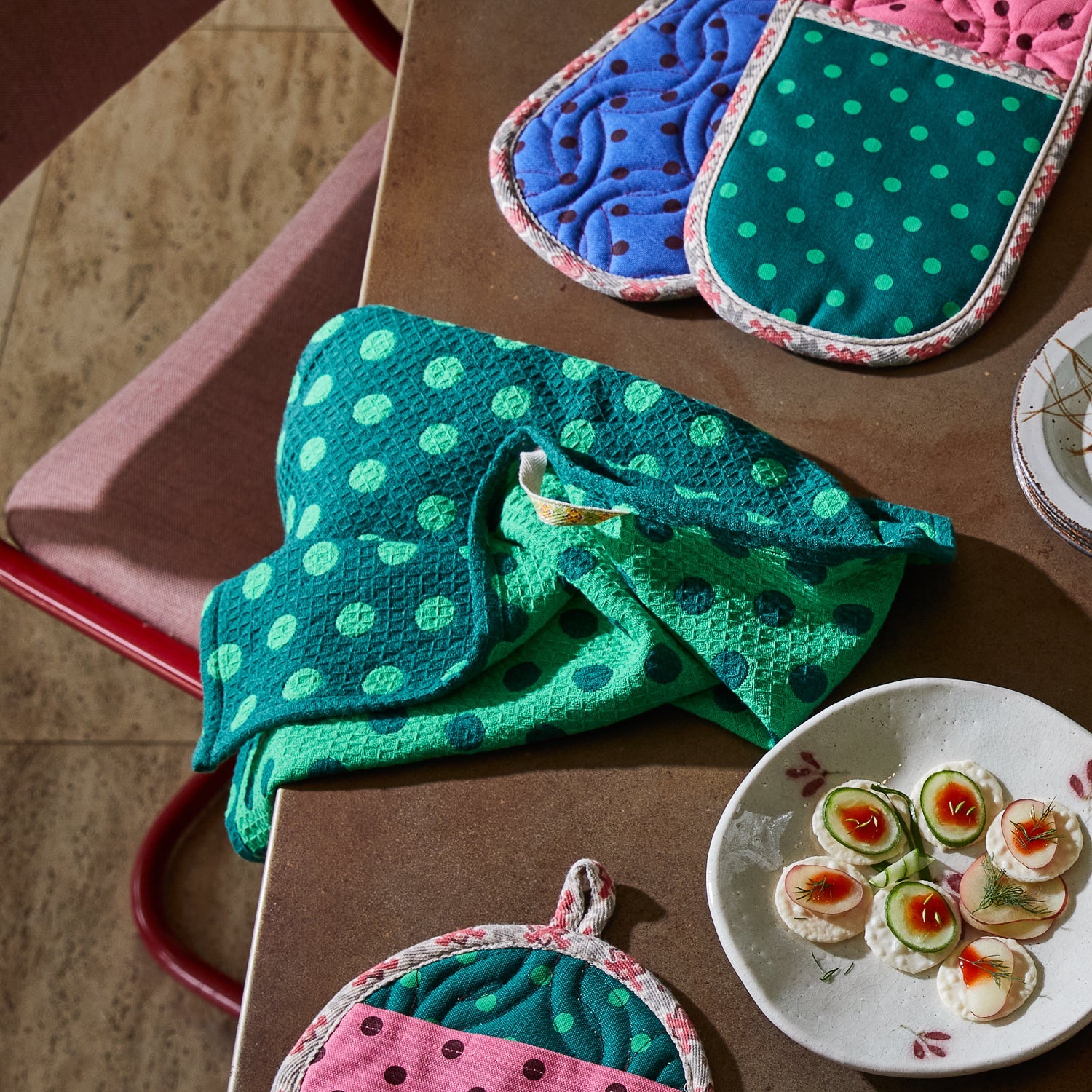 Paige Tea Towel Verdant in kitchen setting with colorful pot holders waffle weave texture absorbent