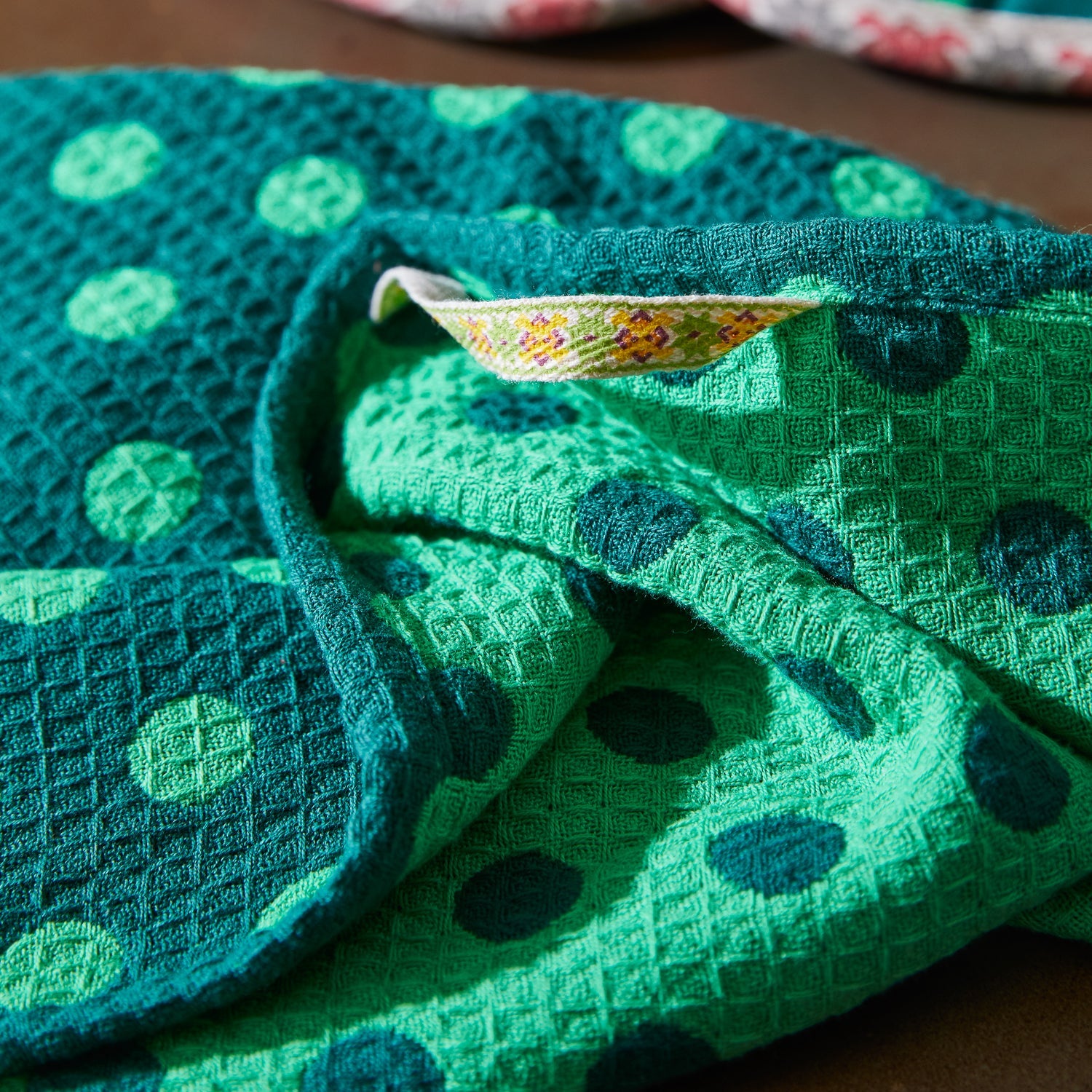 Close-up of Paige Tea Towel waffle weave texture and woven hanging loop with reversible spot design