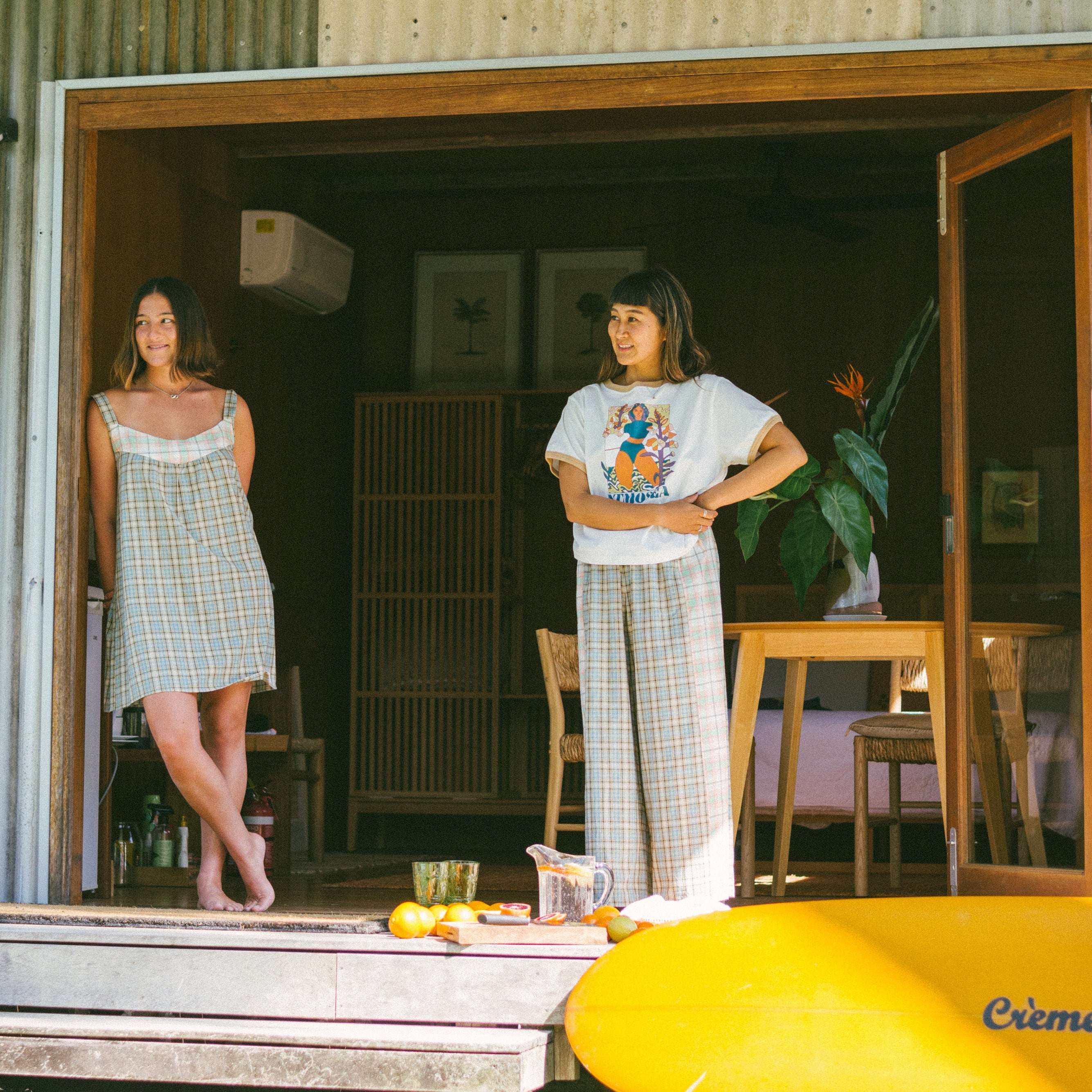 Two ladies on deck, one wearing Patchwork Pant in Cottage Plaid | Atmosea