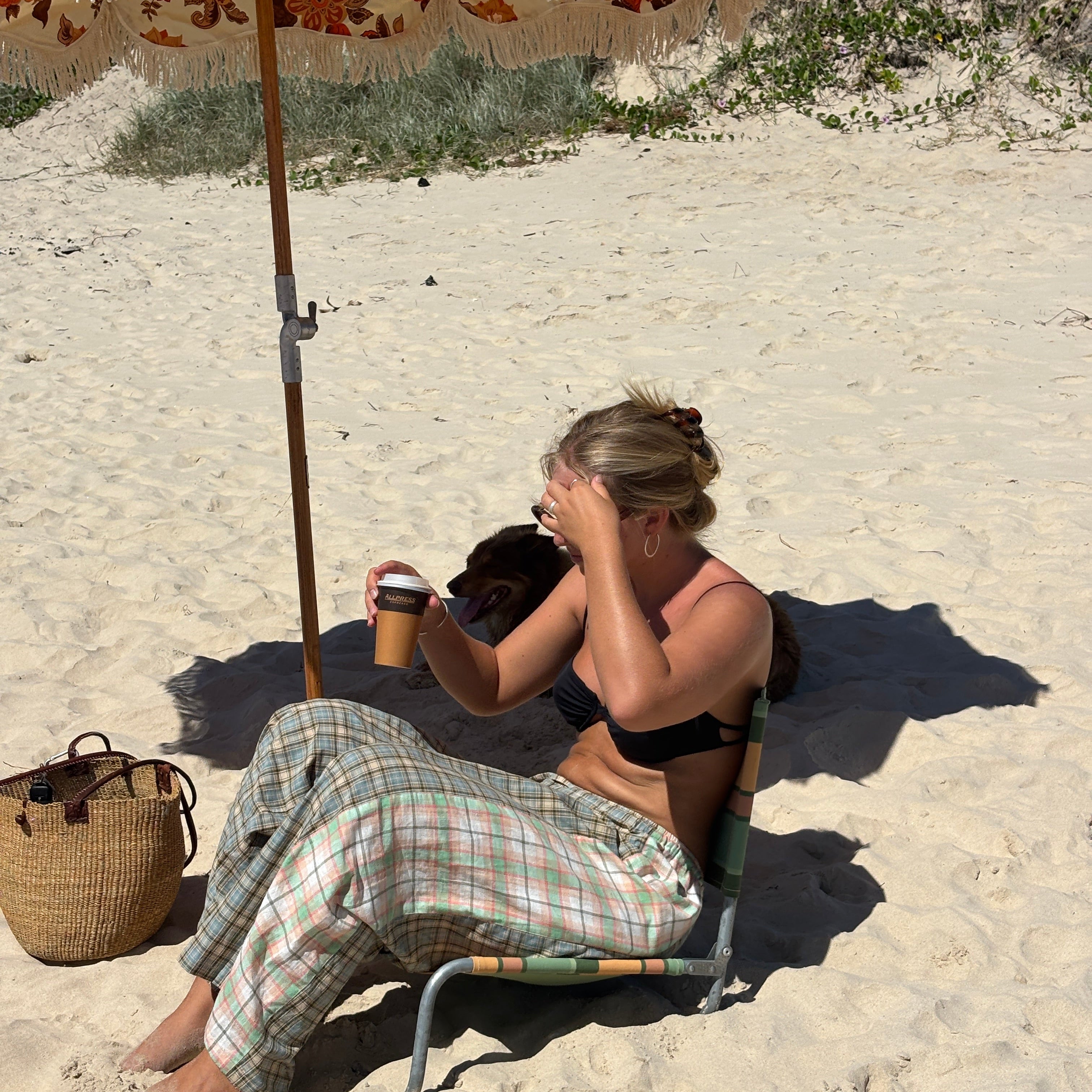 Lady sitting on beach wearing Patchwork Pant in Cottage Plaid | Atmosea