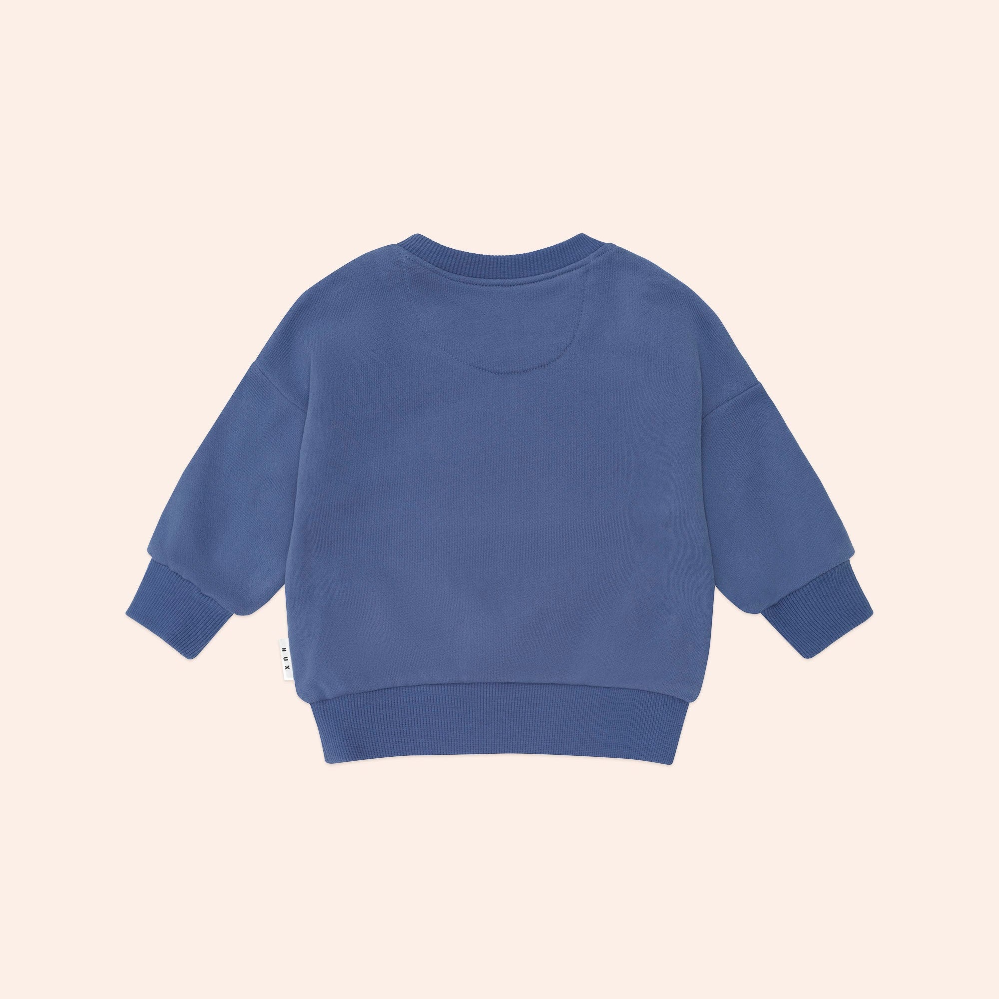 Back view of blue Huxbaby Peekaboo Kel Pocket Sweatshirt showing ribbed cuffs and hemline construction