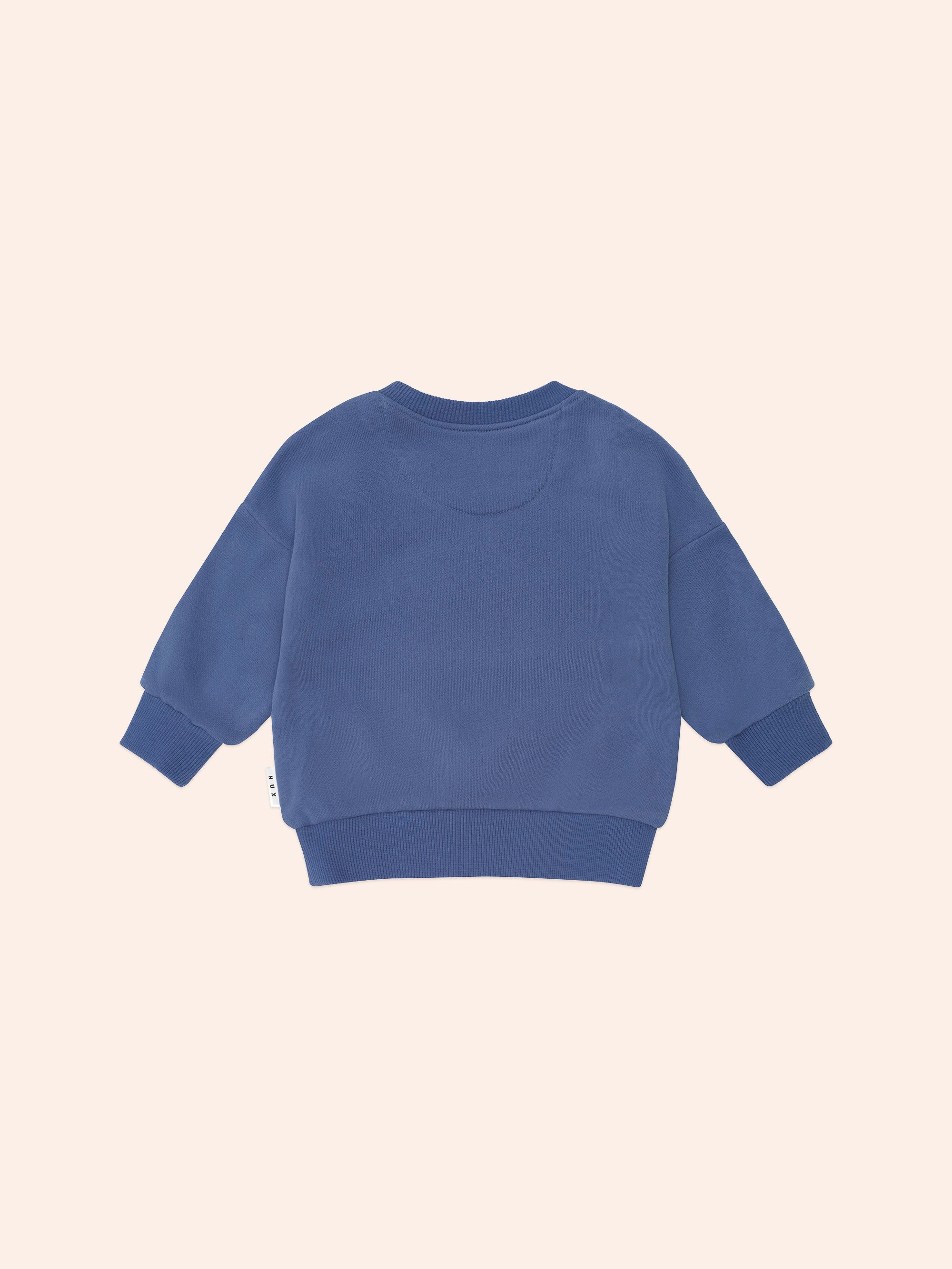 Back view of blue Huxbaby Peekaboo Kel Pocket Sweatshirt showing ribbed cuffs and hemline construction