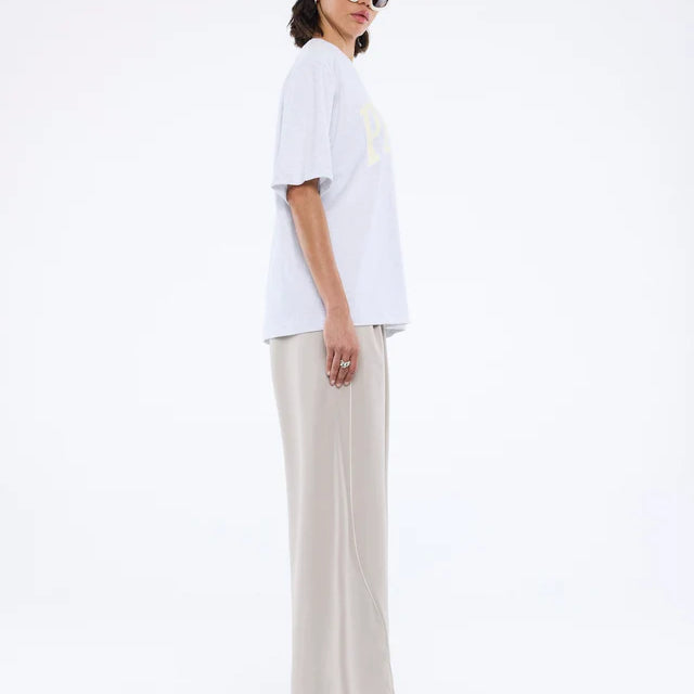 Model side view wearing Pelly Collegiate Tee White Marle by Ena Pelly