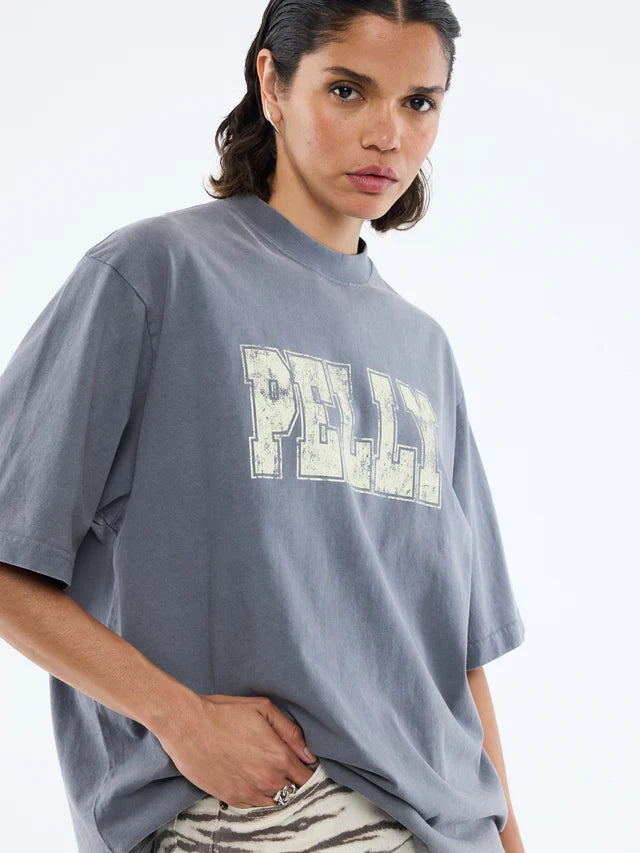 Grey tshirt with the word "Pelly" in offwhite across the front