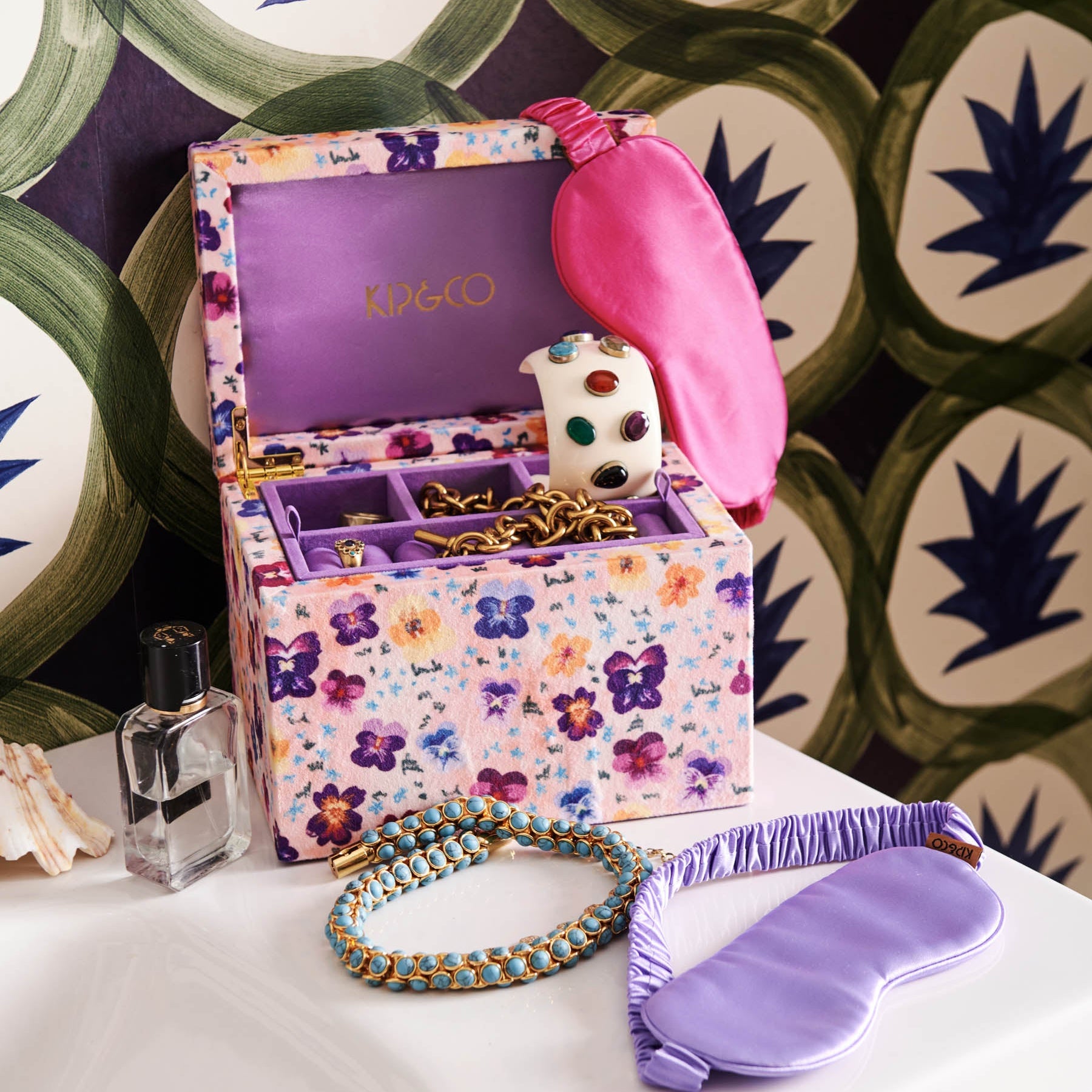 Kip & Co Perfect Pink Silk Eye Mask displayed in open floral jewelry box with purple silk eye mask