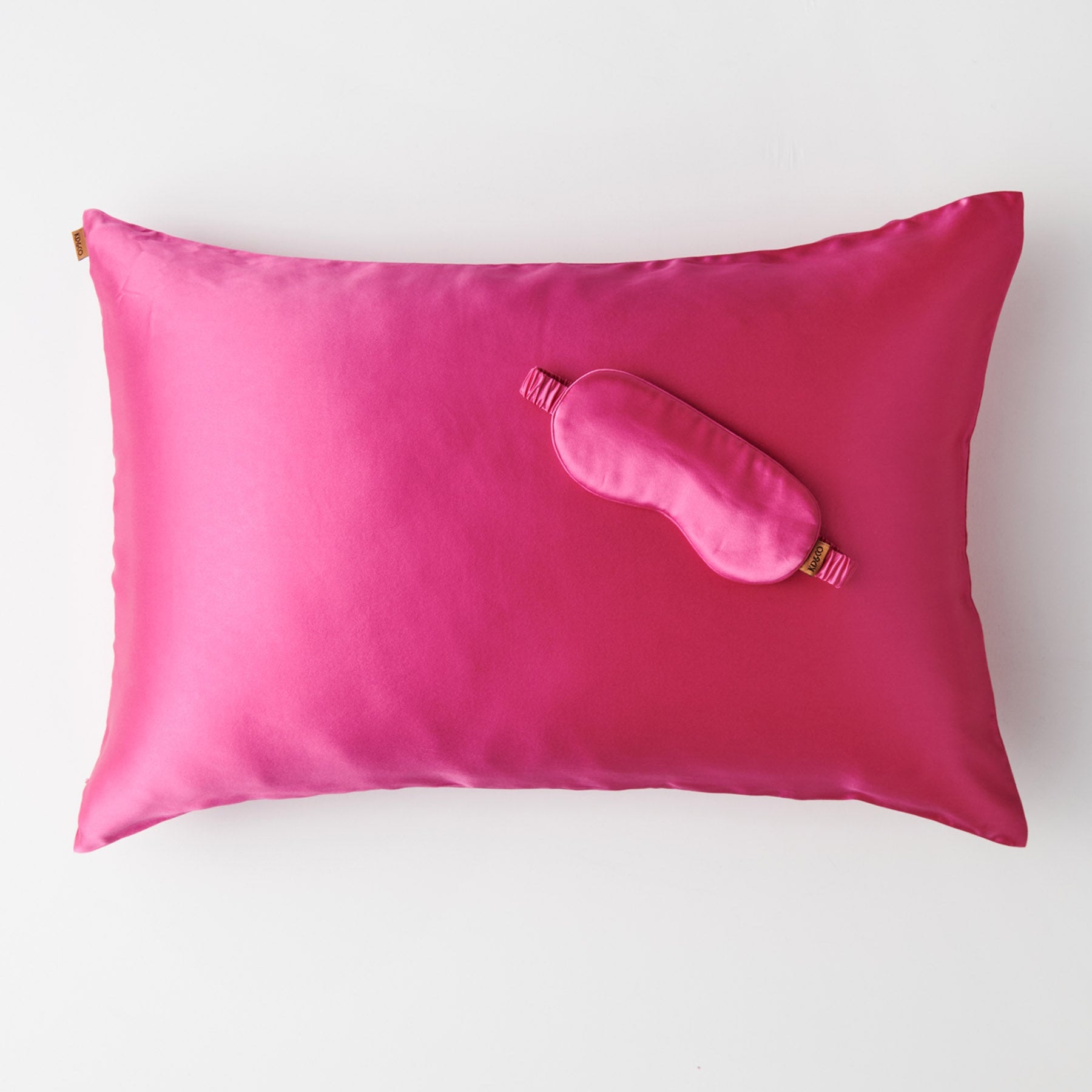 Top view Perfect Pink Silk Eye Mask on matching pink silk pillowcase showing smooth lustrous texture