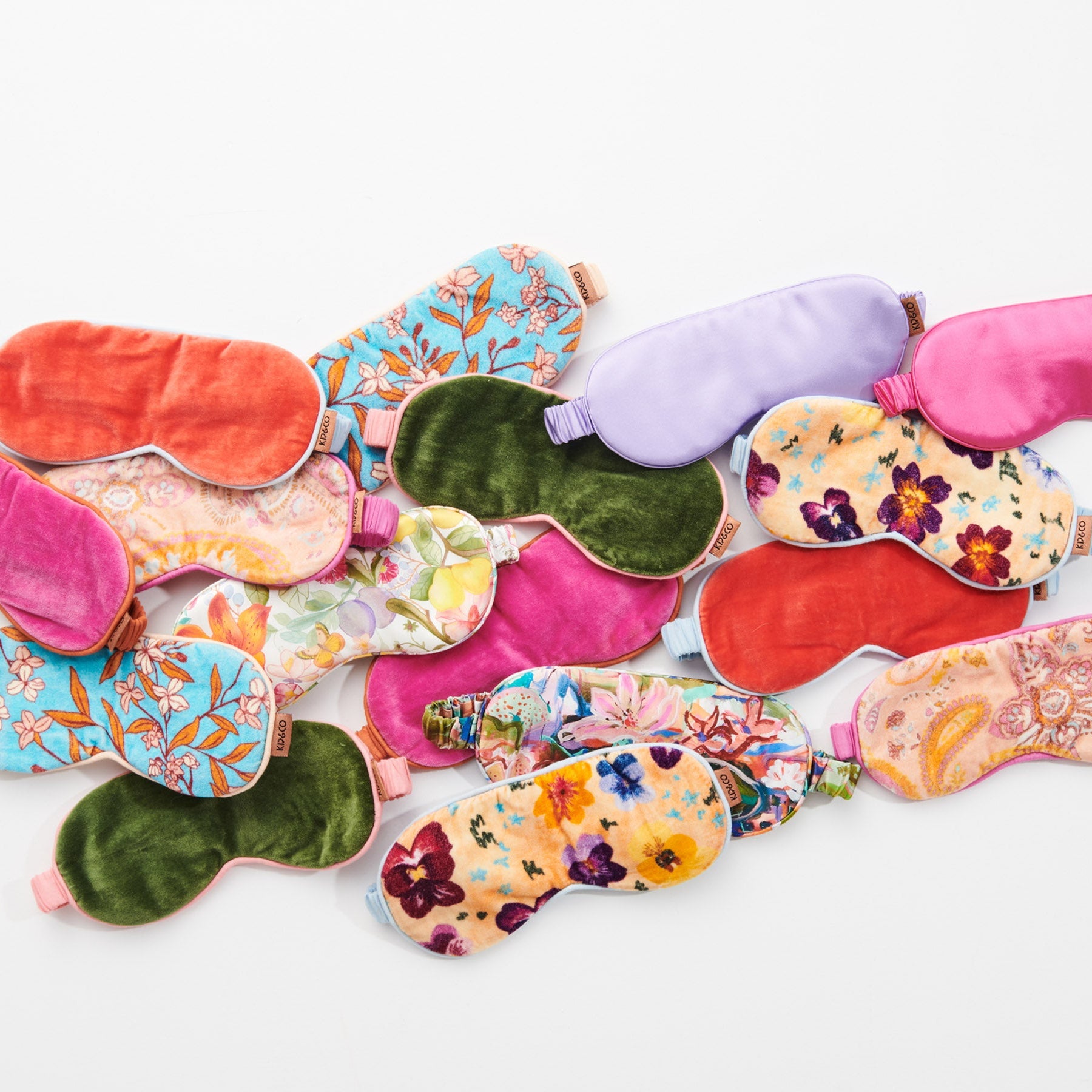 Collection of colorful Kip & Co silk eye masks including Perfect Pink with various floral patterns