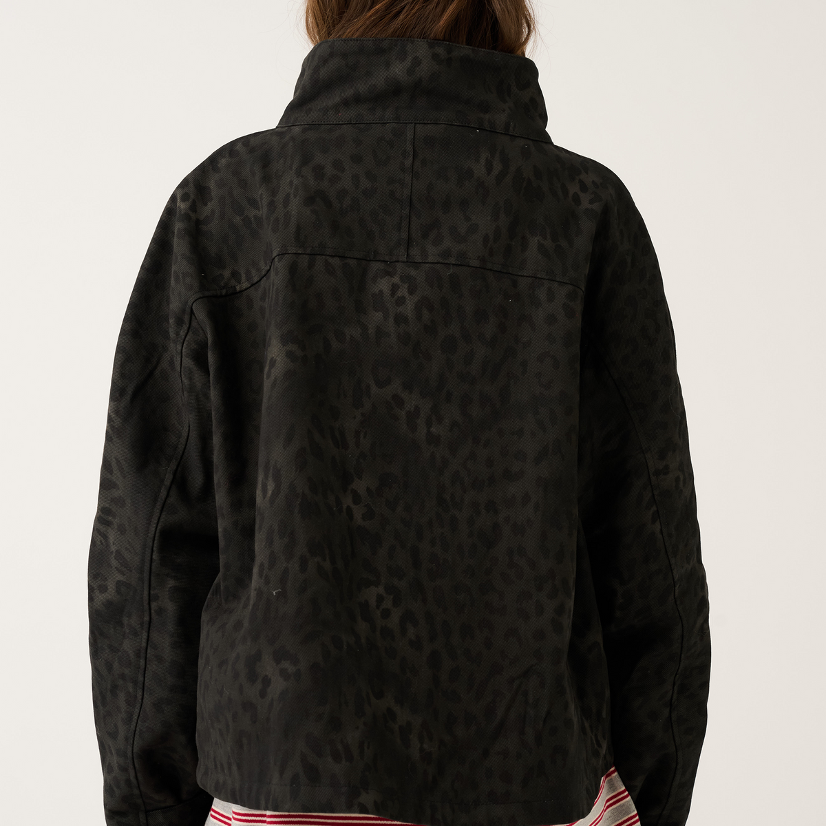 Back view of black washed leopard print oversized jacket showing tonal animal print and high collar