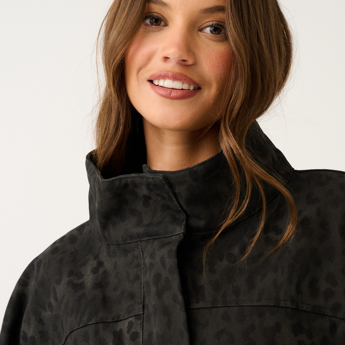 Close-up detail of black washed leopard print jacket collar and tonal animal-print fabric texture
