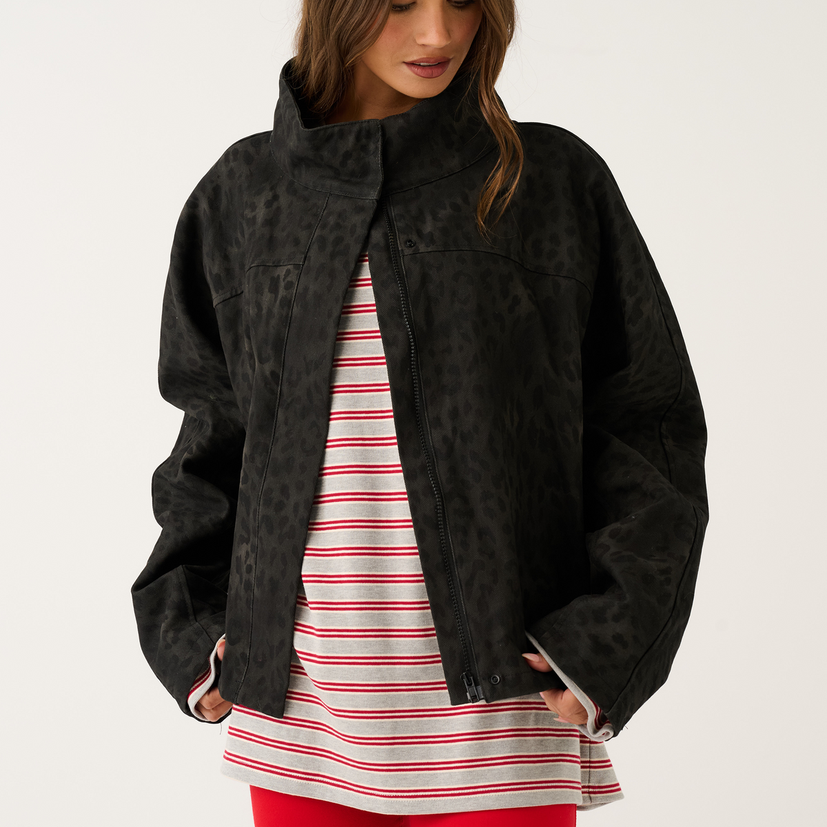 Black washed leopard print oversized jacket worn open showing centre zip, front three-quarter view