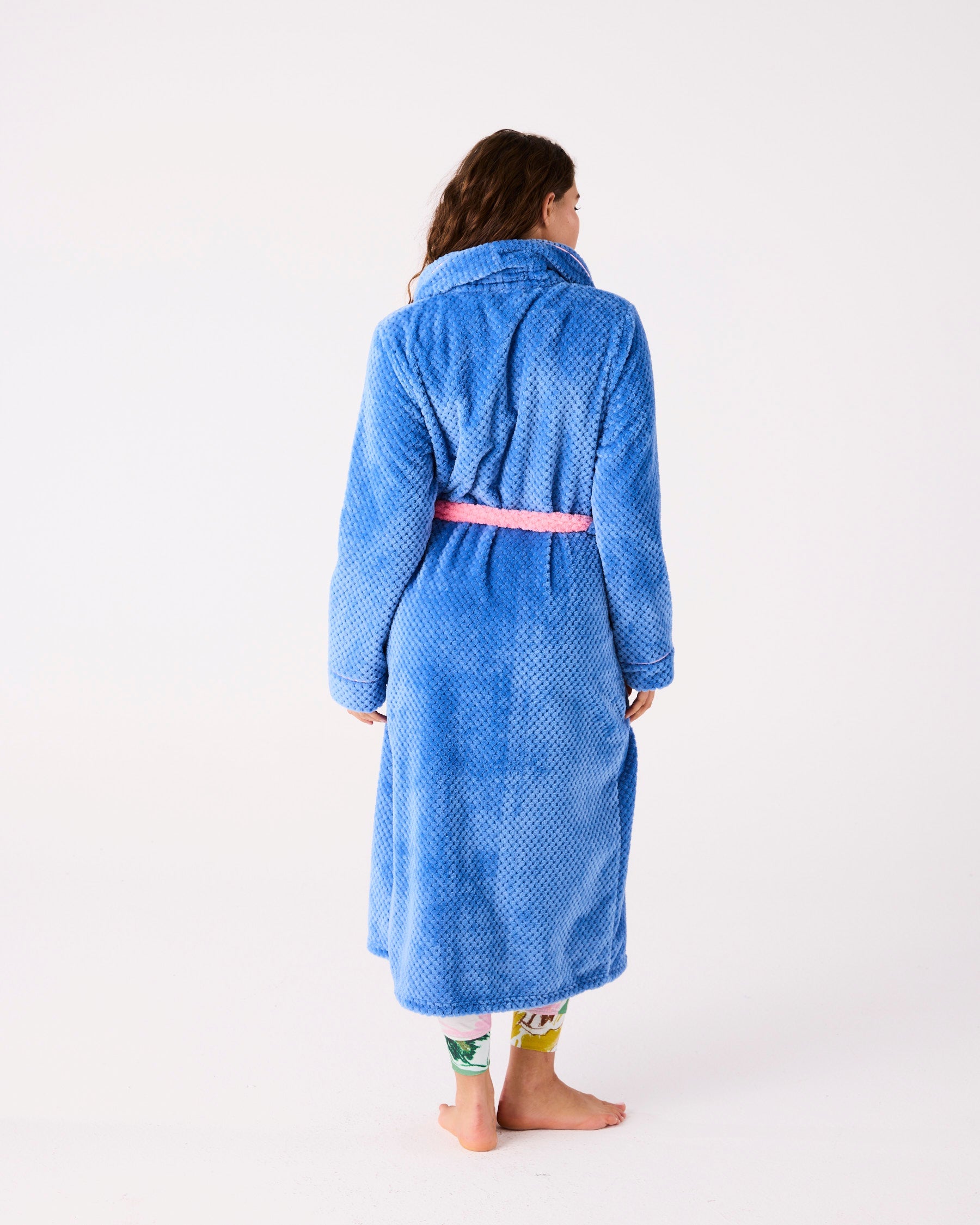 Back view of woman wearing blue Pie In The Sky Adult Cosy Robe showing full length and pink belt
