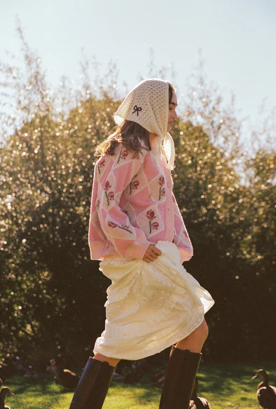 Lady wearing a head scarf and wearing the Rosie Cardigan by JUNI