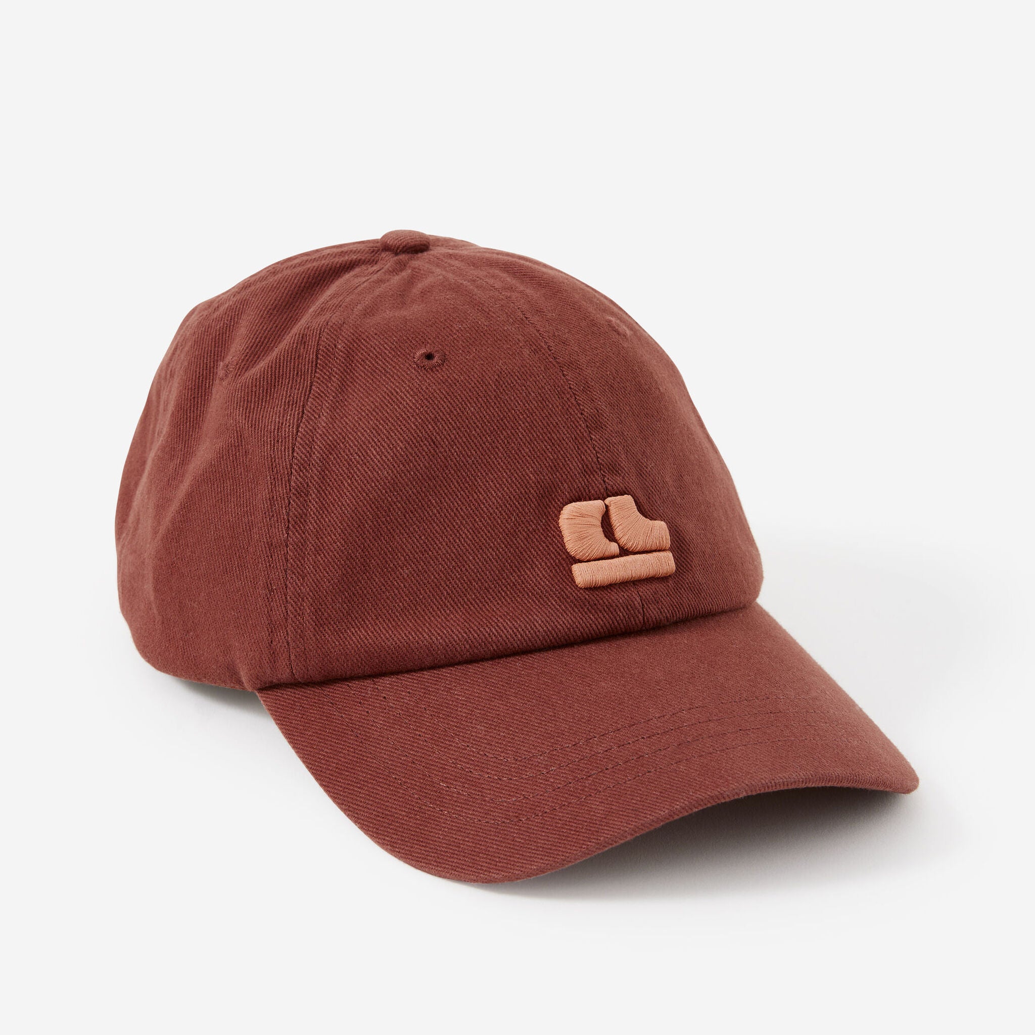 Front view of Pip Everyday Cap in burnt toffee color showing pink clay embroidered logo detail