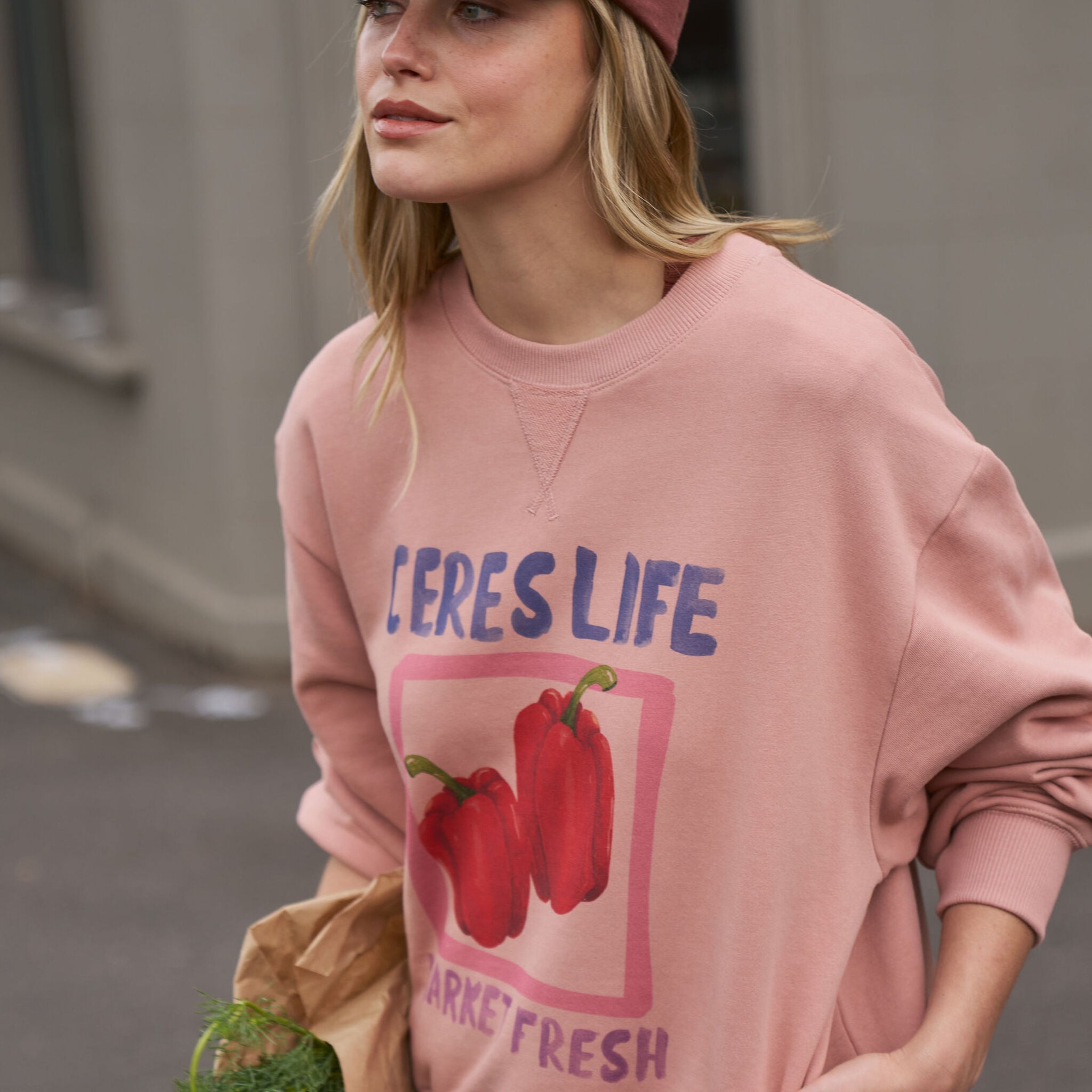 Side profile of woman wearing Pip Everyday Cap in burnt toffee with pink clay logo patch