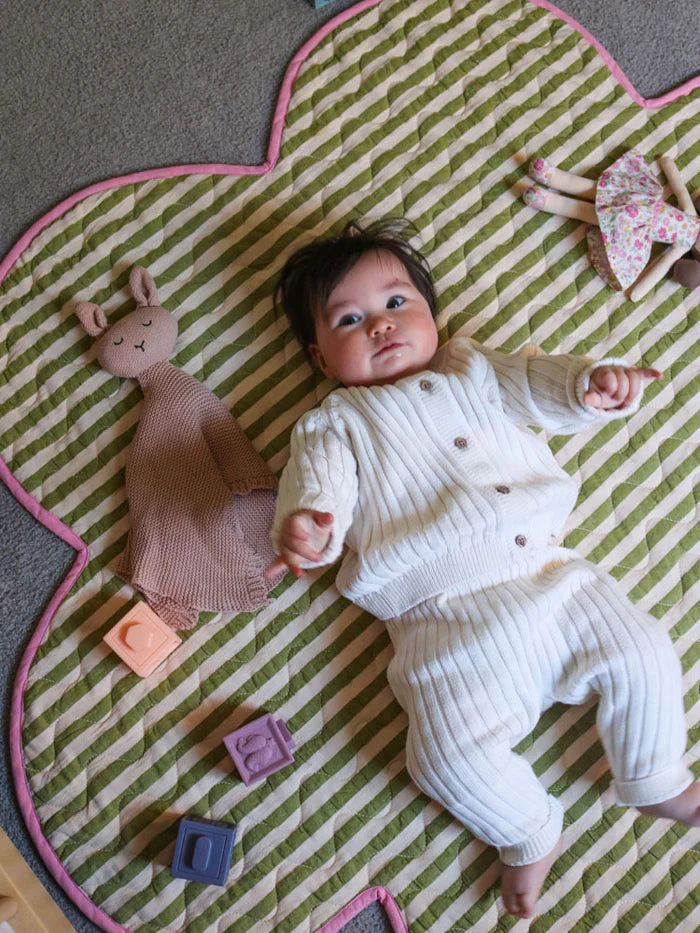baby laying on Pistachio Seersucker Playmat by Mosey Me