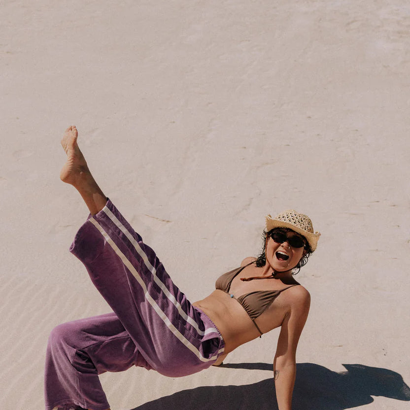 Purple terry towelling pants with stripes down the side