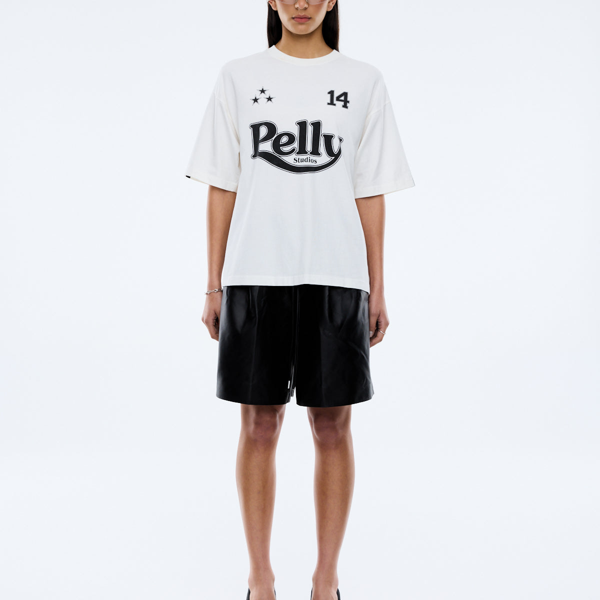 model wearing Racing Pelly Swoop tee showing sleeve stripe design and vintage wash cotton fabric texture