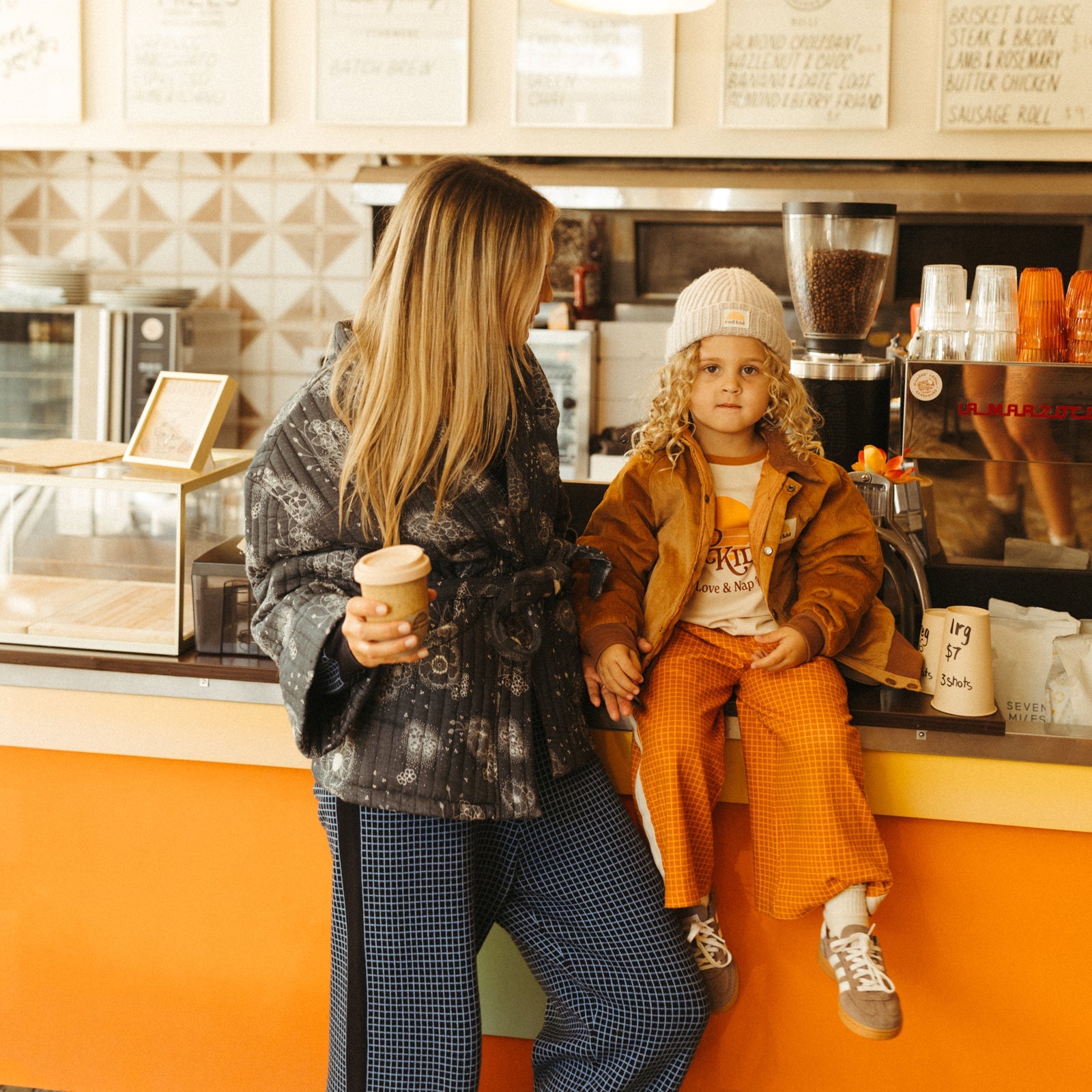 Mother and child modeling matching Banabae pajama sets in cozy living room setting