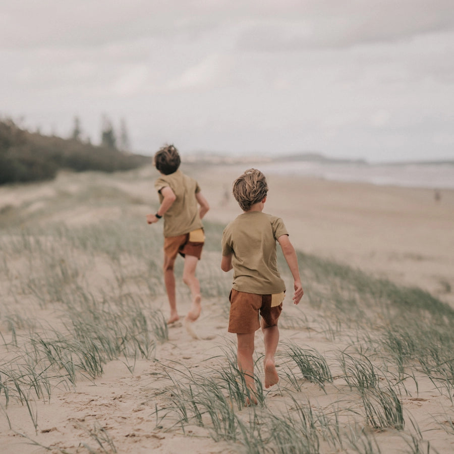 Rad Kid Spliced Cord Shorts by Banabae boys running along the beach wearing the banabae kids shorts