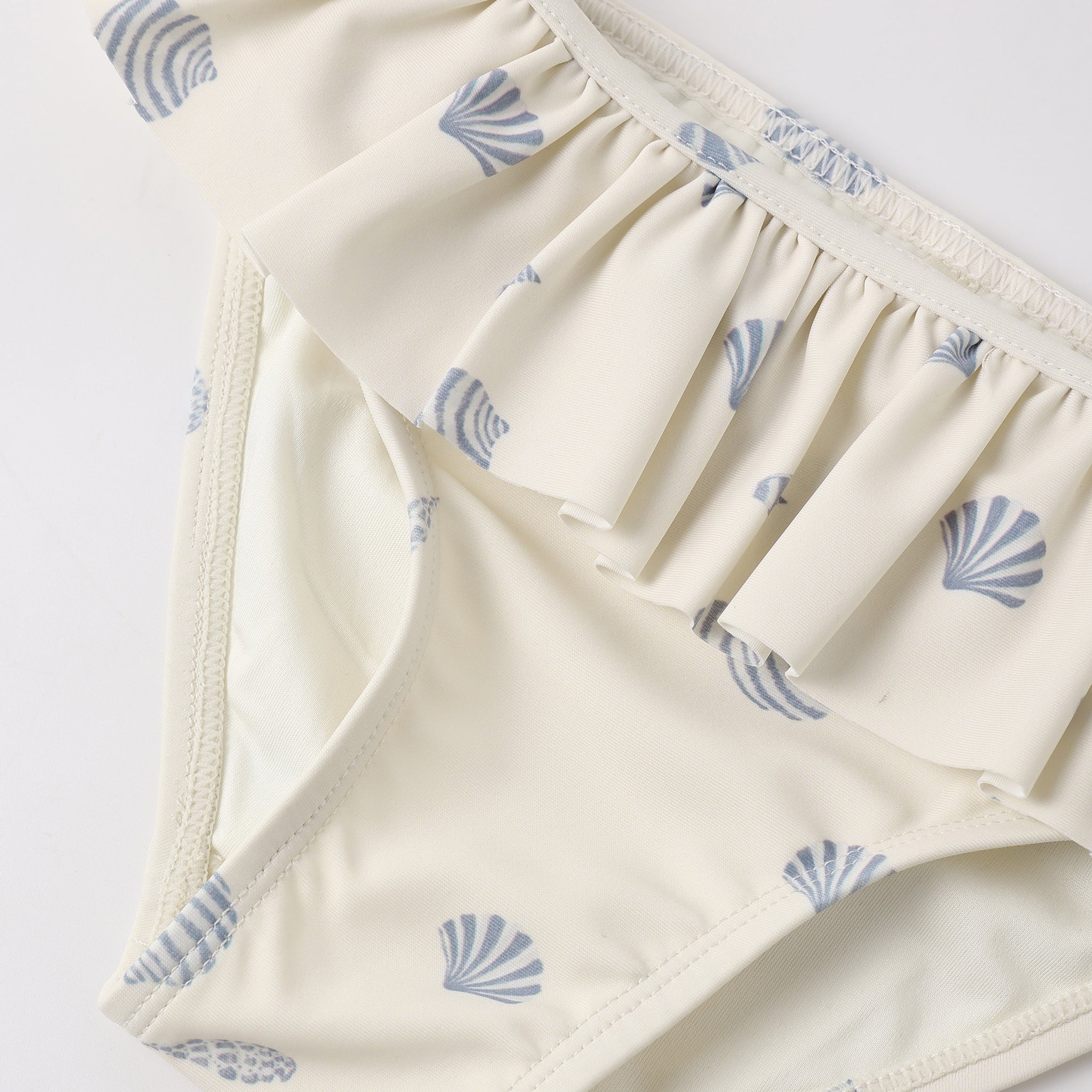 Close up of bottoms on the Rash guard Girls Set Seashells | Rylee + Cru