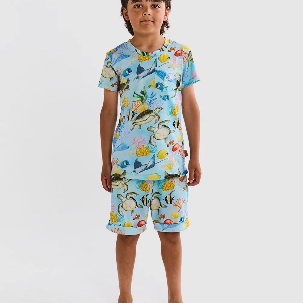 boy wearing Kip & Co Pyjamas - Kip & Co Reef Life Kids Organic Cotton Short Sleeve Tee & Short Pyjama Set