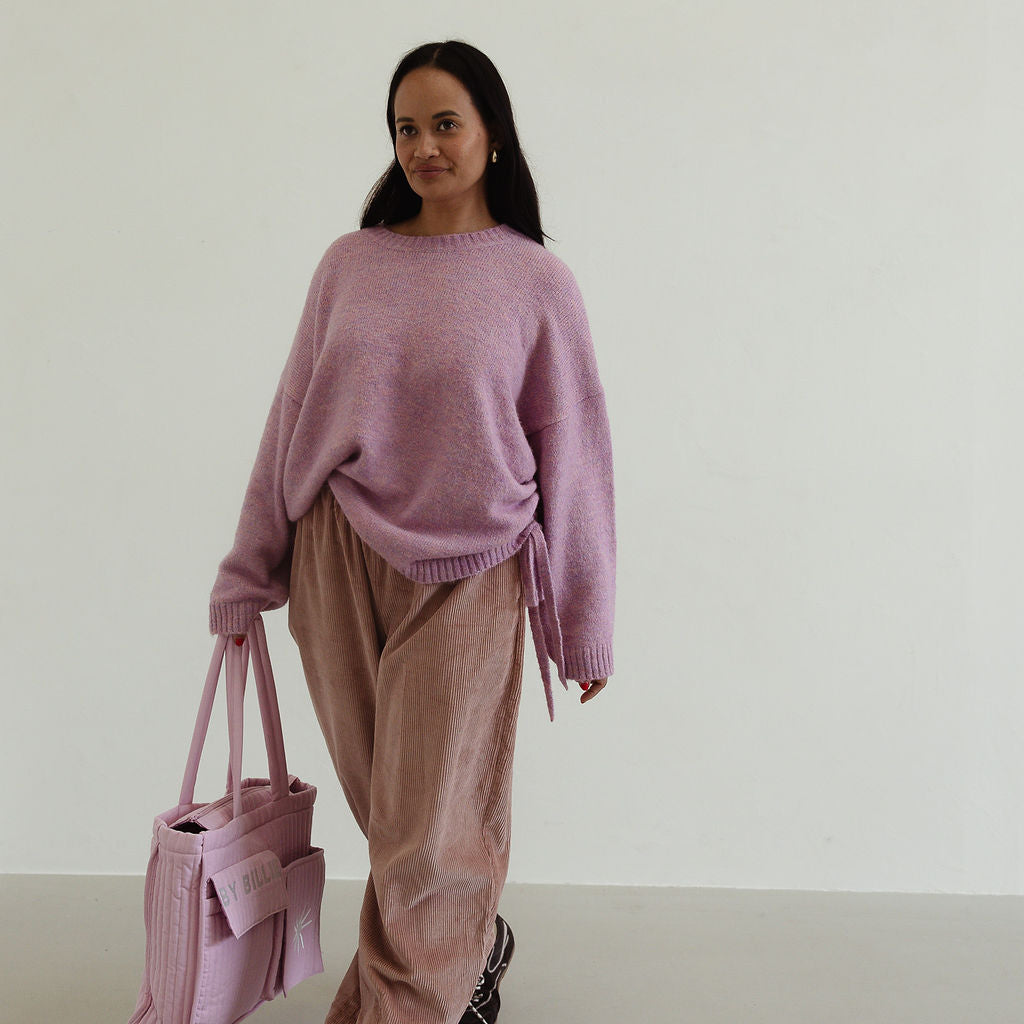Side angle of Ren Cord Pant in musk pink displaying wide-leg shape and comfortable fit