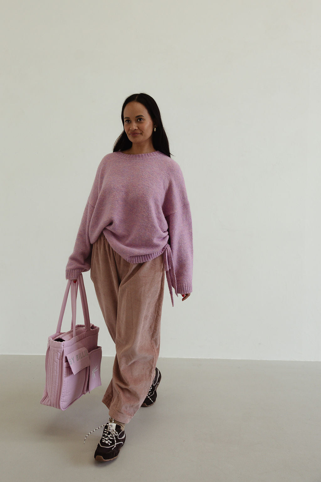 Side angle of Ren Cord Pant in musk pink displaying wide-leg shape and comfortable fit